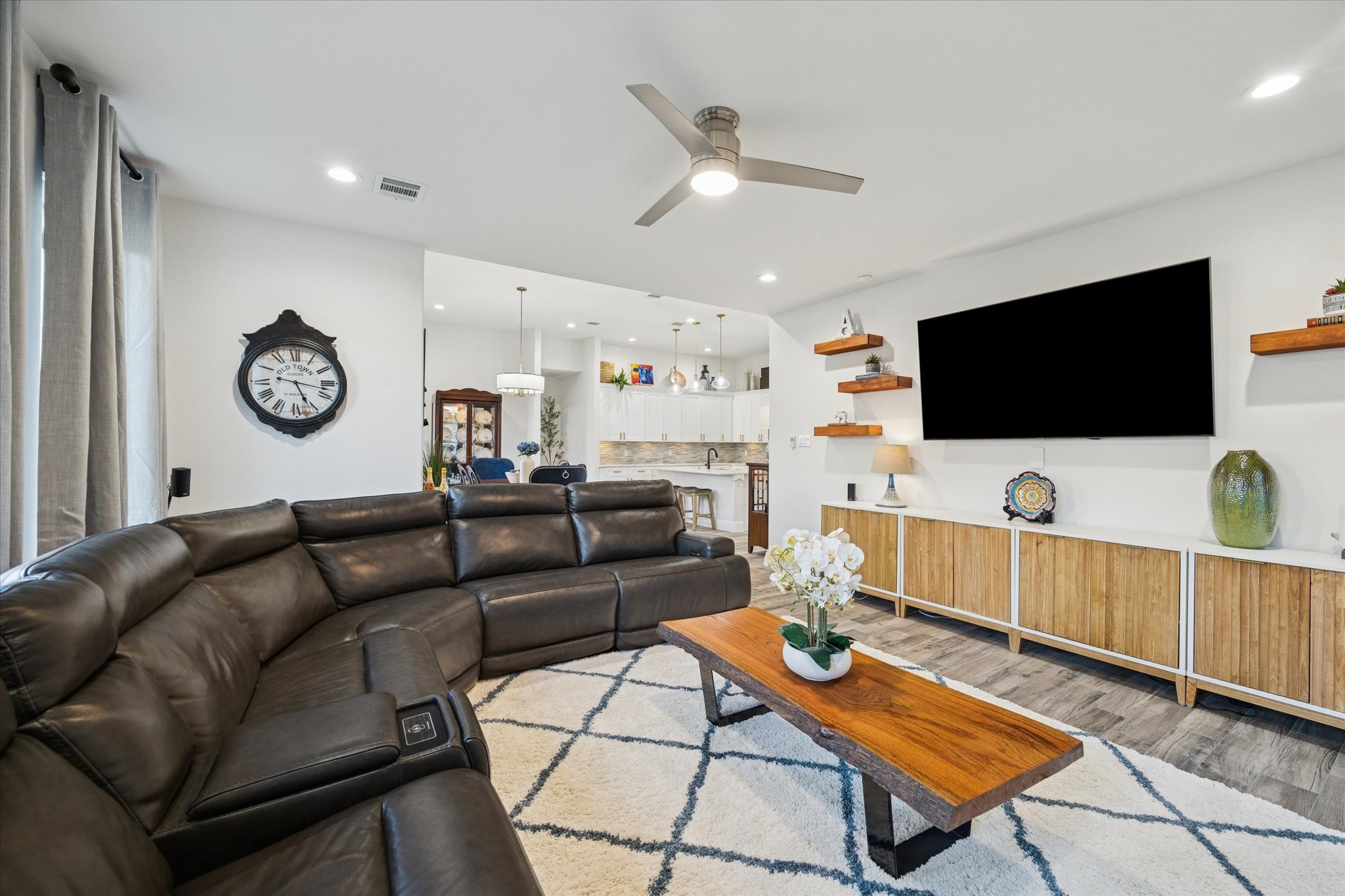 A spacious and functional open-concept layout designed to stay connected between the living room, kitchen, and breakfast area, while maintaining an open, comfortable flow. Recently installed shelving provides the perfect place to subtly display dcor and cherished photos. Abundant natural light fills the area, creating a bright atmosphere while supporting energy efficiency.