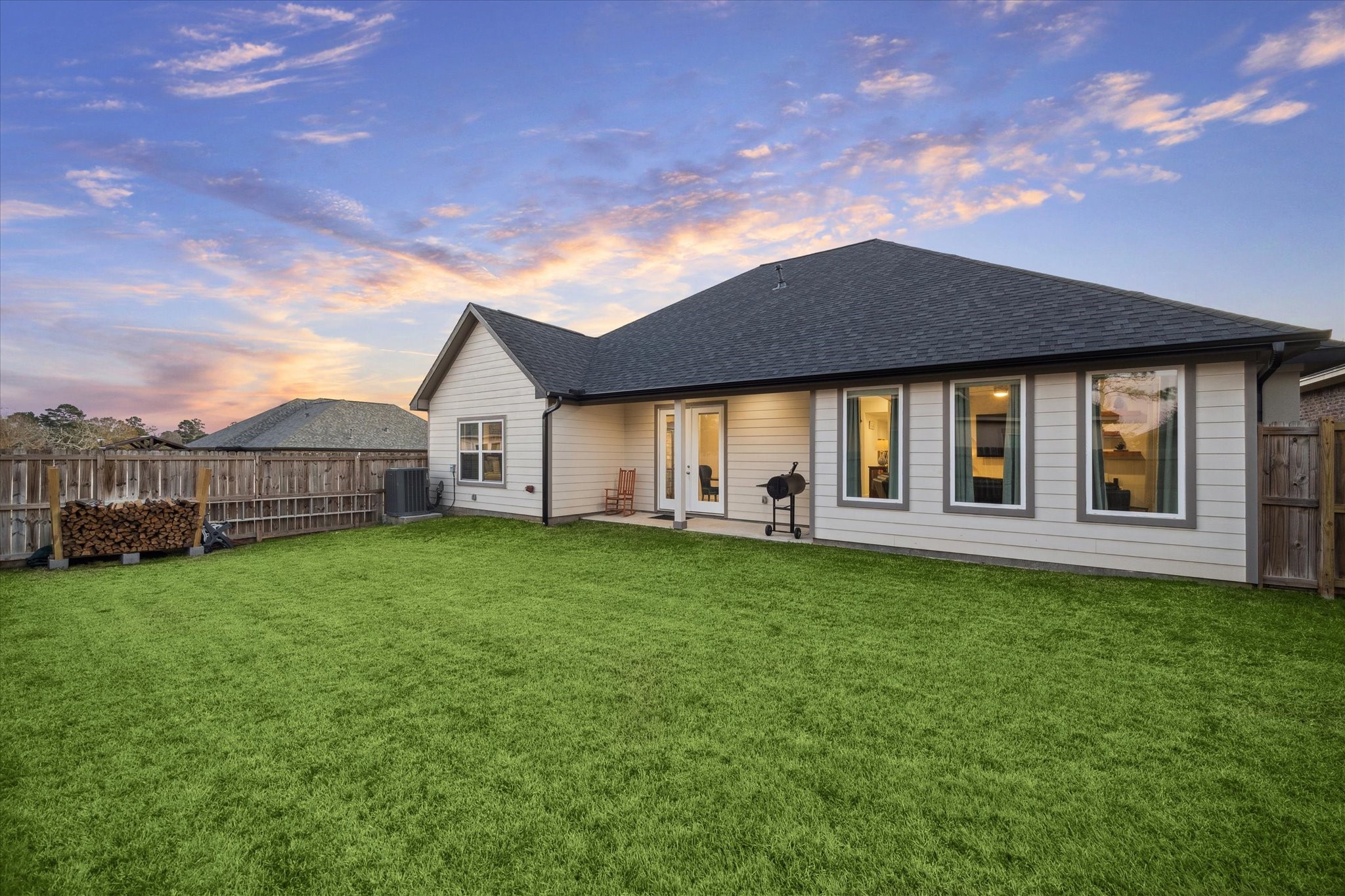 This angle of the right side of the patio highlights the corner-lot location, offering both privacy and convenience. The garage is positioned with access to the side street, providing ease for residents and guests.