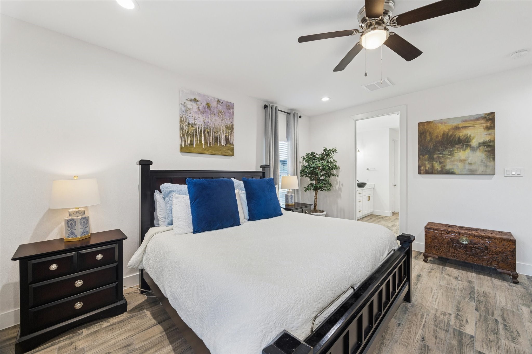 This angle of the primary bedroom highlights its generous size and abundant natural light, creating a bright and inviting retreat. The view also showcases the convenient location of the ensuite bathroom, emphasizing a seamless and functional layout. The combination of space, light, and thoughtful design creates a truly luxurious primary suite.