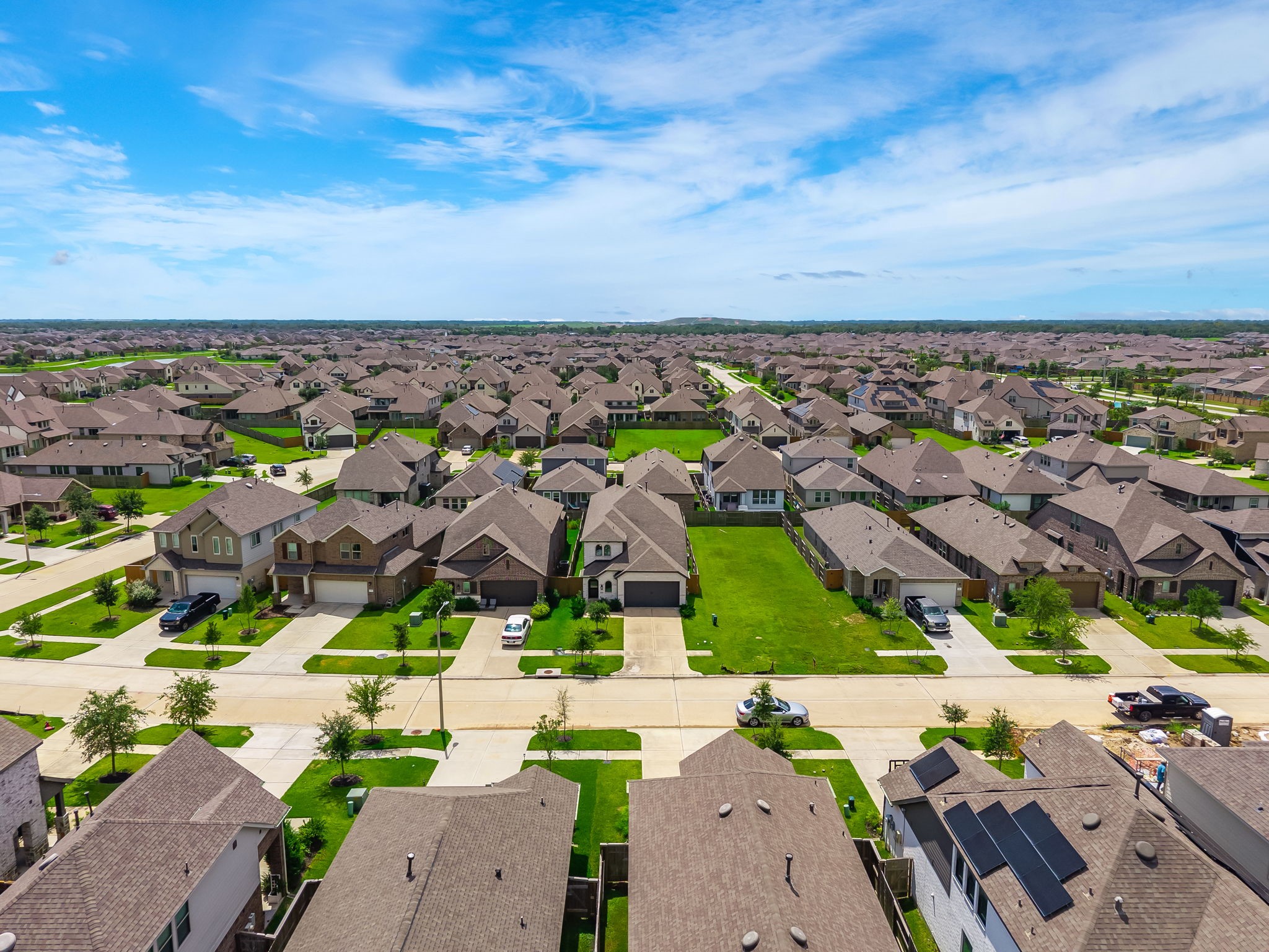 The aerial view captures the surrounding Lago Mar neighborhood, green space, and nearby homes. It adds scale and context to the community setting. Virtually staged.
