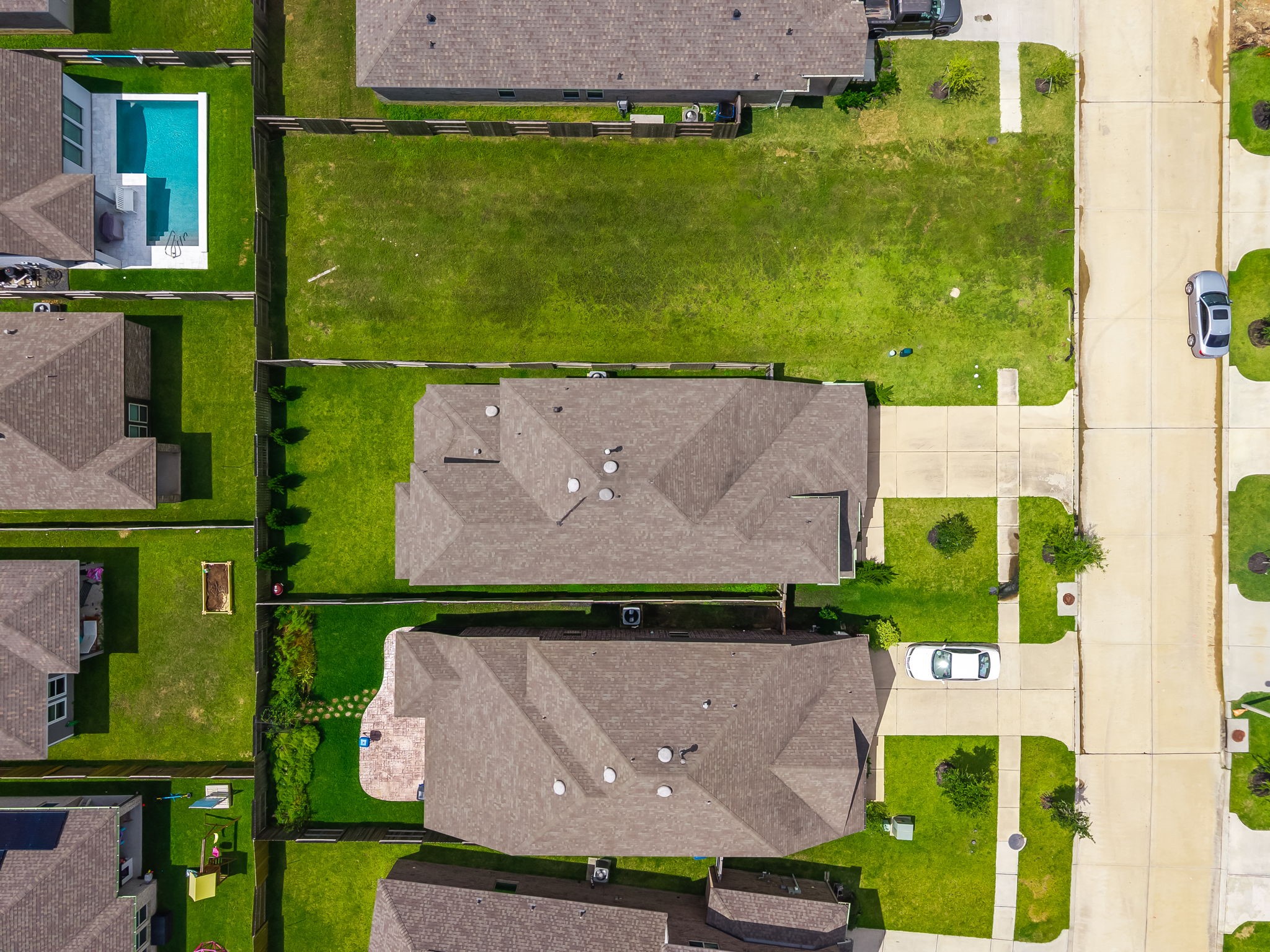 The overhead view highlights the homes roofline, driveway, backyard, and lot placement within Lago Mar. A clear look at the propertys setting. Virtually staged.