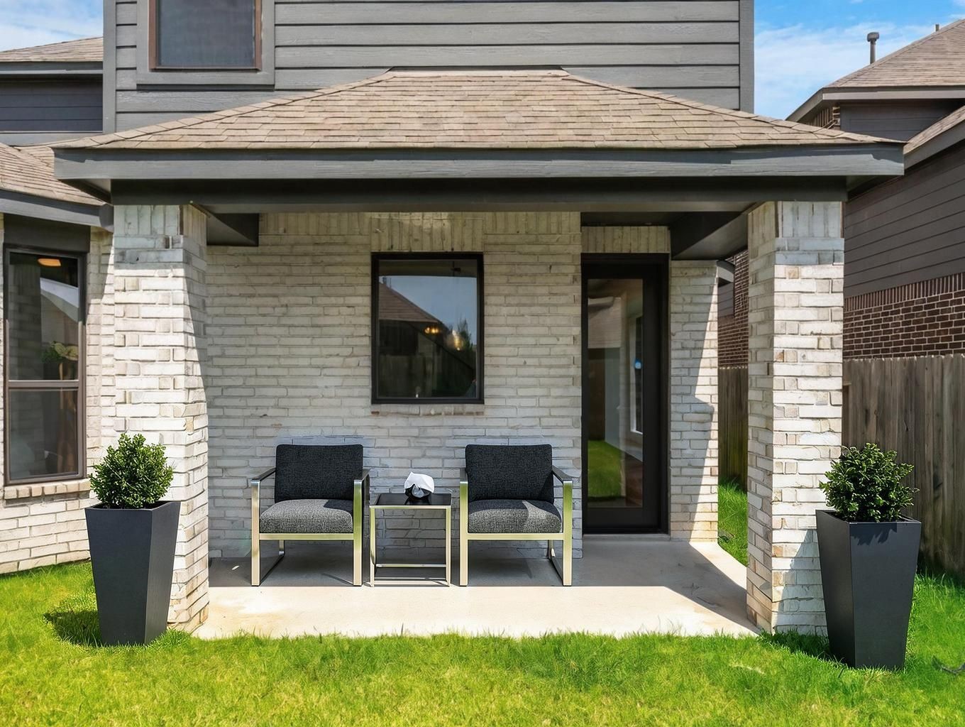 The covered patio creates a quiet outdoor extension just off the back of the home. A simple, shaded space for lounging, dining, or evening air. Virtually staged.
