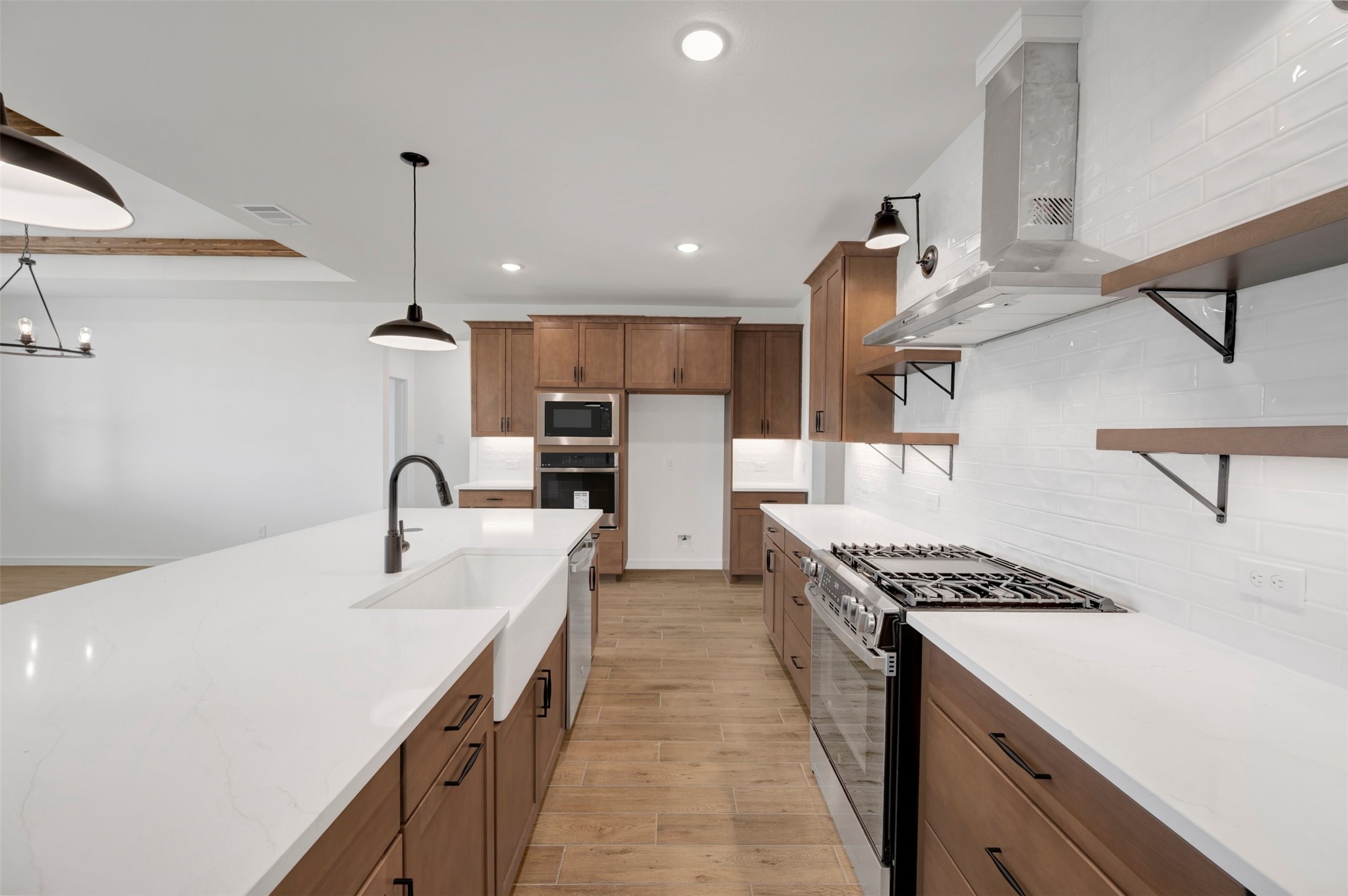 Chef-worthy kitchen with chestnut brown cabinets and quartz counters