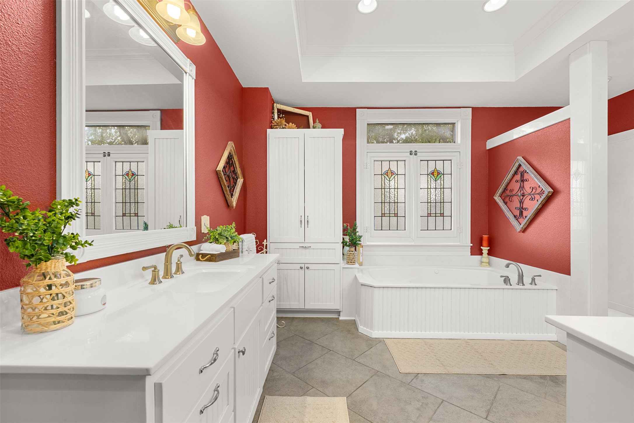 Dual vanities provide generous personal space and storage within the large primary bath.