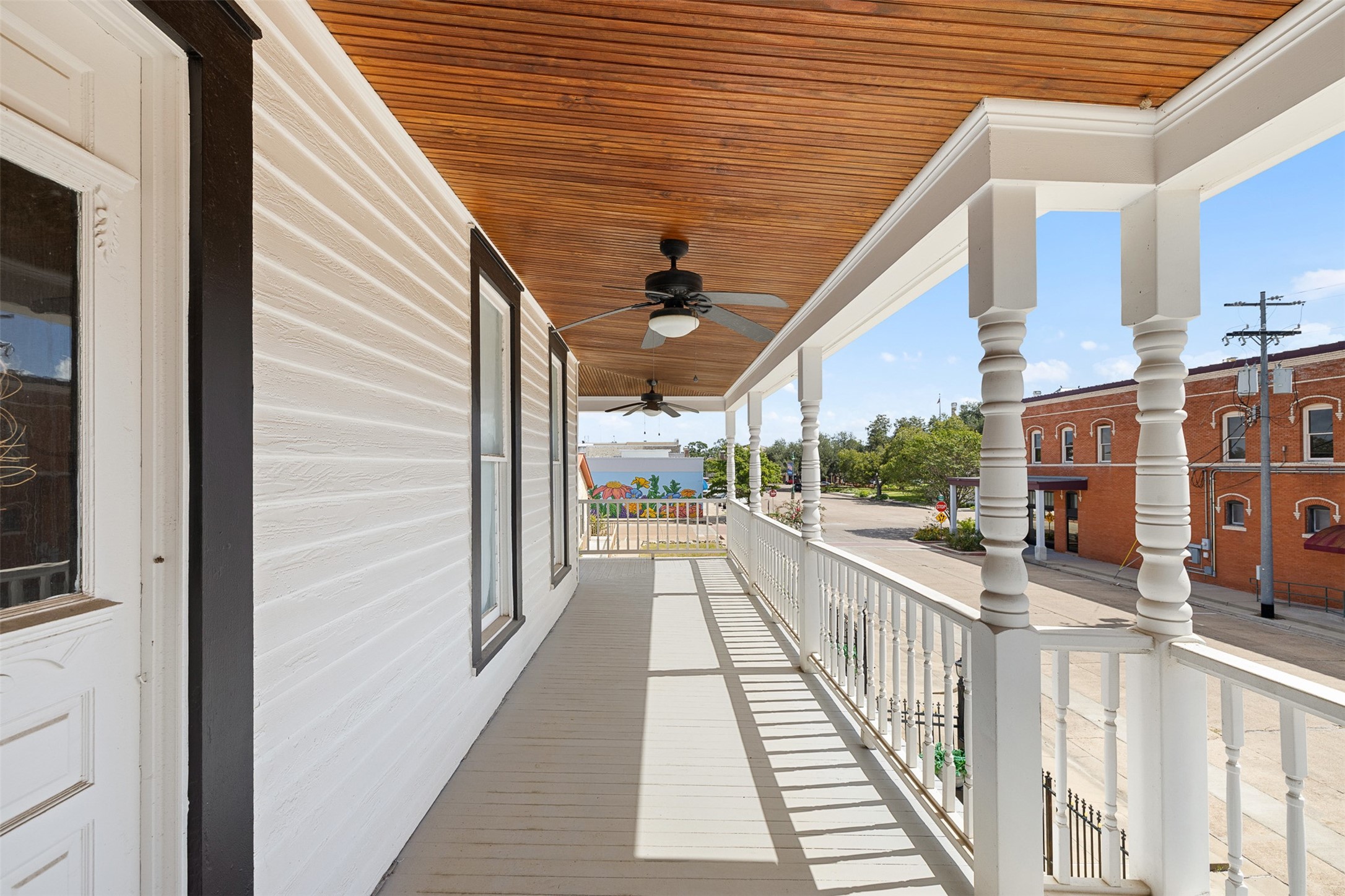 The long upper balcony captures the romance of Southern living and offers views toward the heart of La Grange.