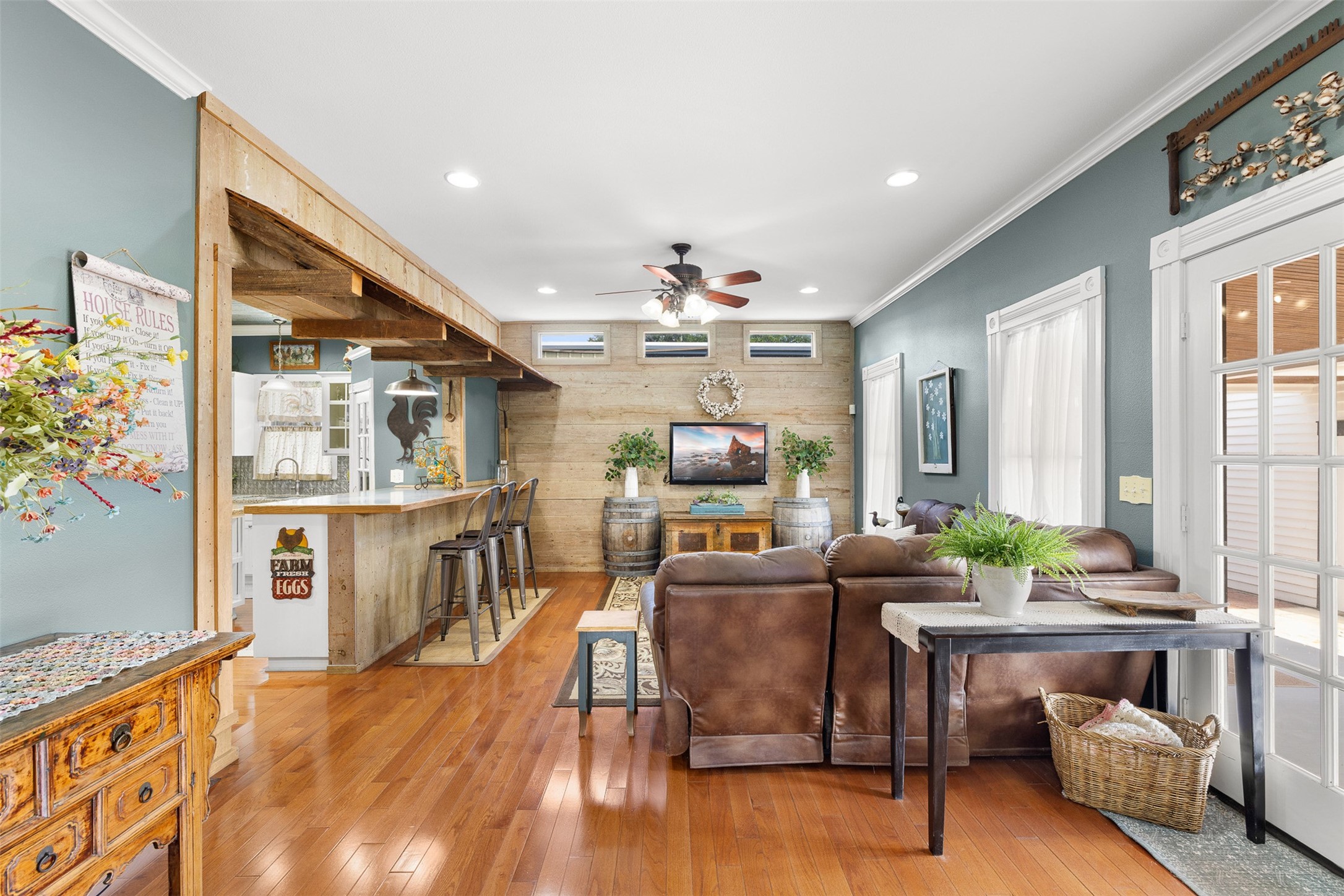 Rich wood floors and an open connection to the kitchen make the family room comfortable, inviting and ideal for gathering.