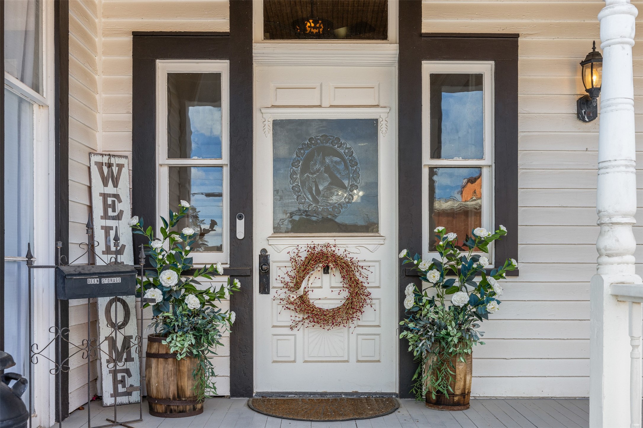 Original acid-etched front door and doorbell with the welcoming porch introduce the homes remarkable historic character.