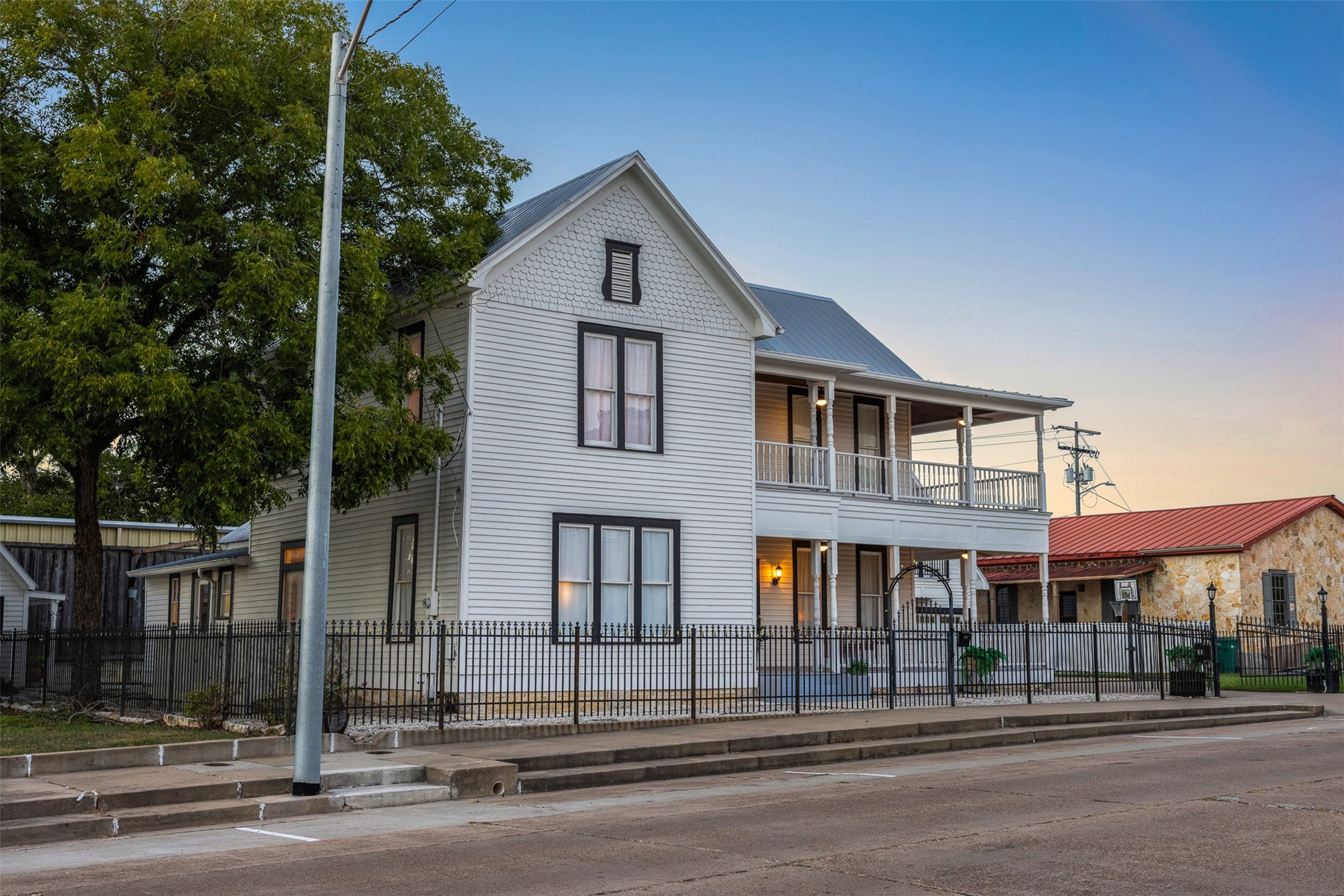 As evening falls, the homes crisp Victorian architecture takes on a warm and romantic glow.