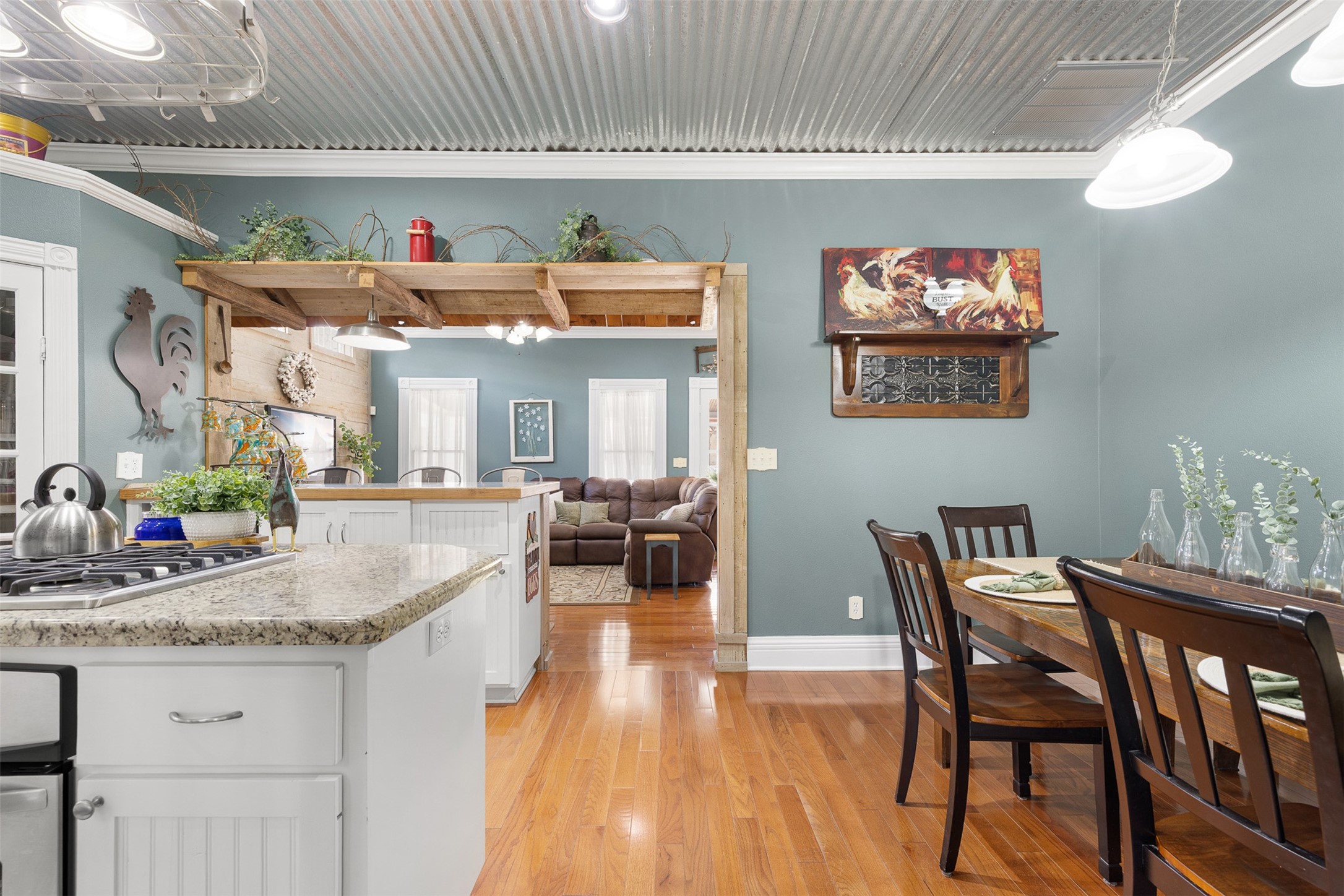 An open view from the kitchen toward the dining area and family room highlights the homes warm and connected layout.