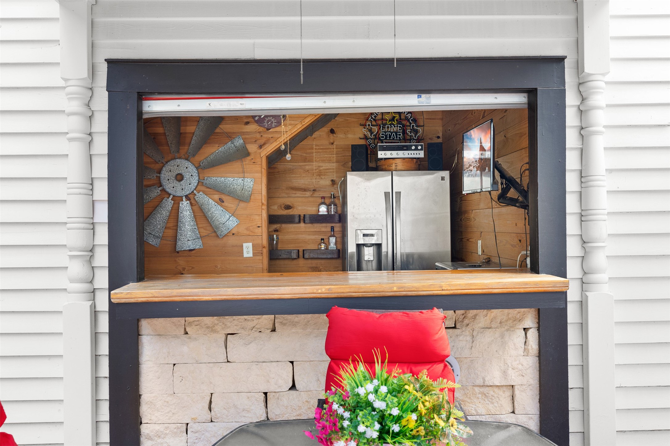 The garage bars charming serving window adds personality and makes entertaining especially easy.