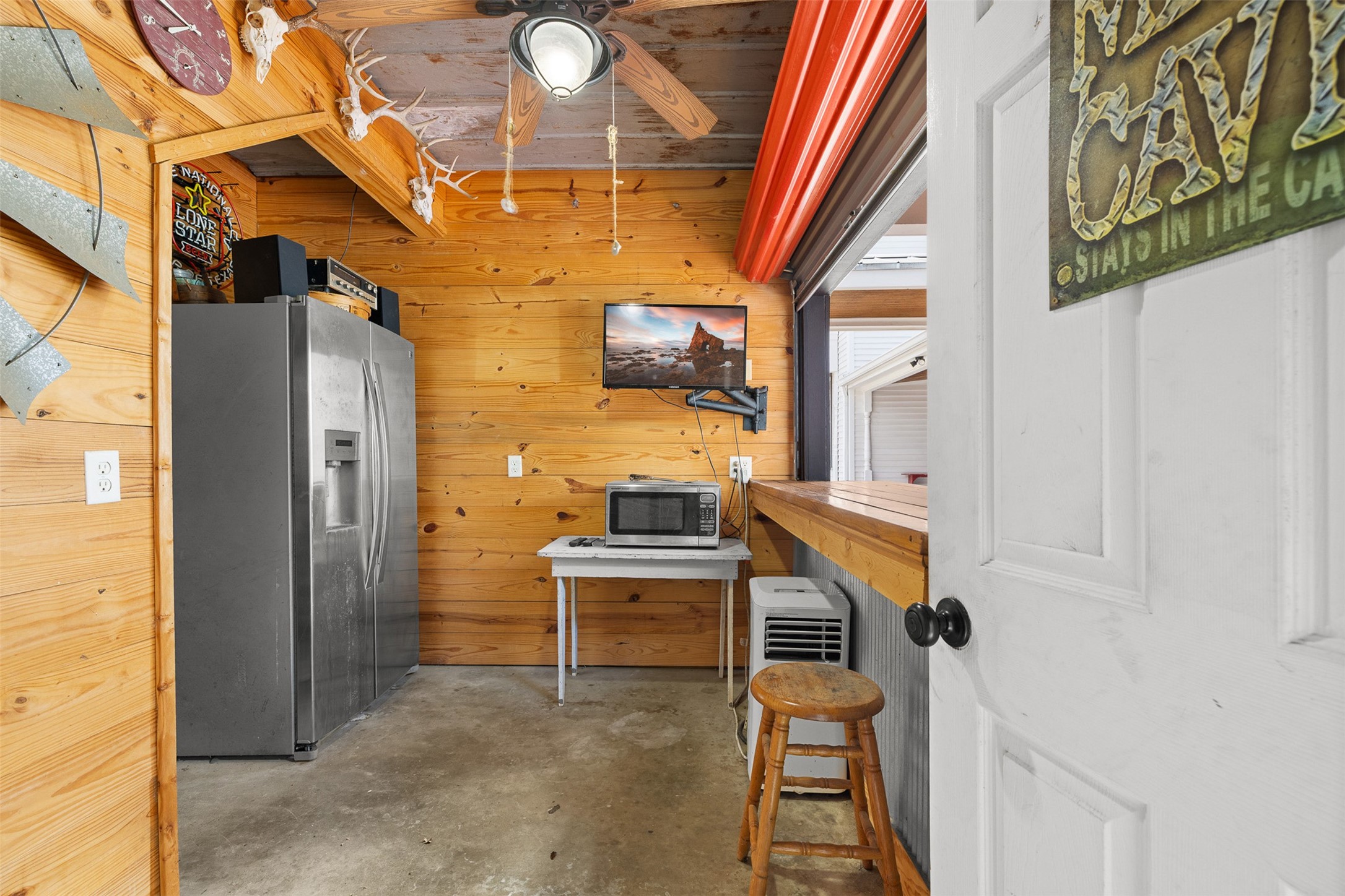 A casual bar and gathering area within the garage creates a fun and flexible extension of the property.