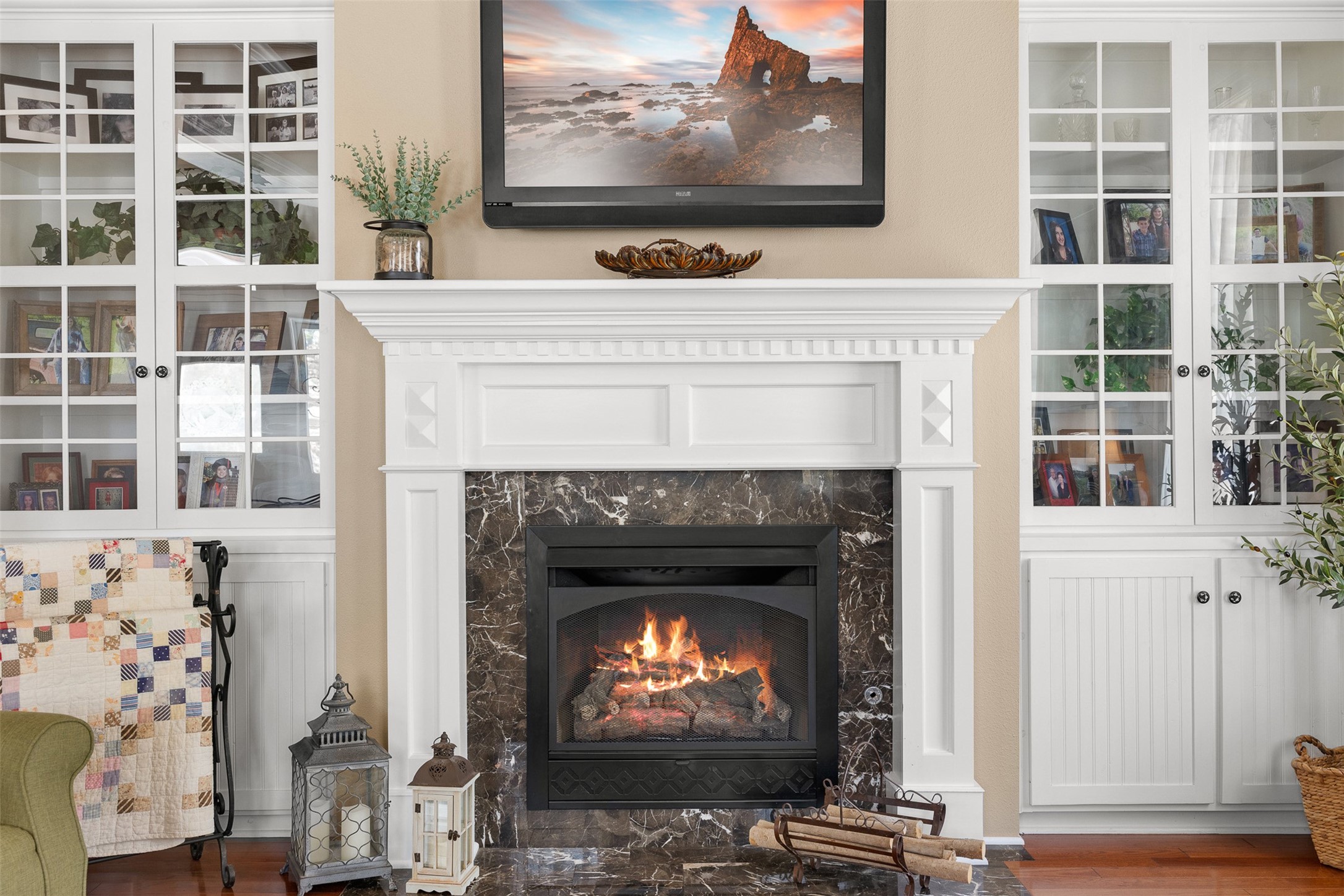 A stately fireplace framed by custom built-ins creates an elegant focal point in the formal living room.