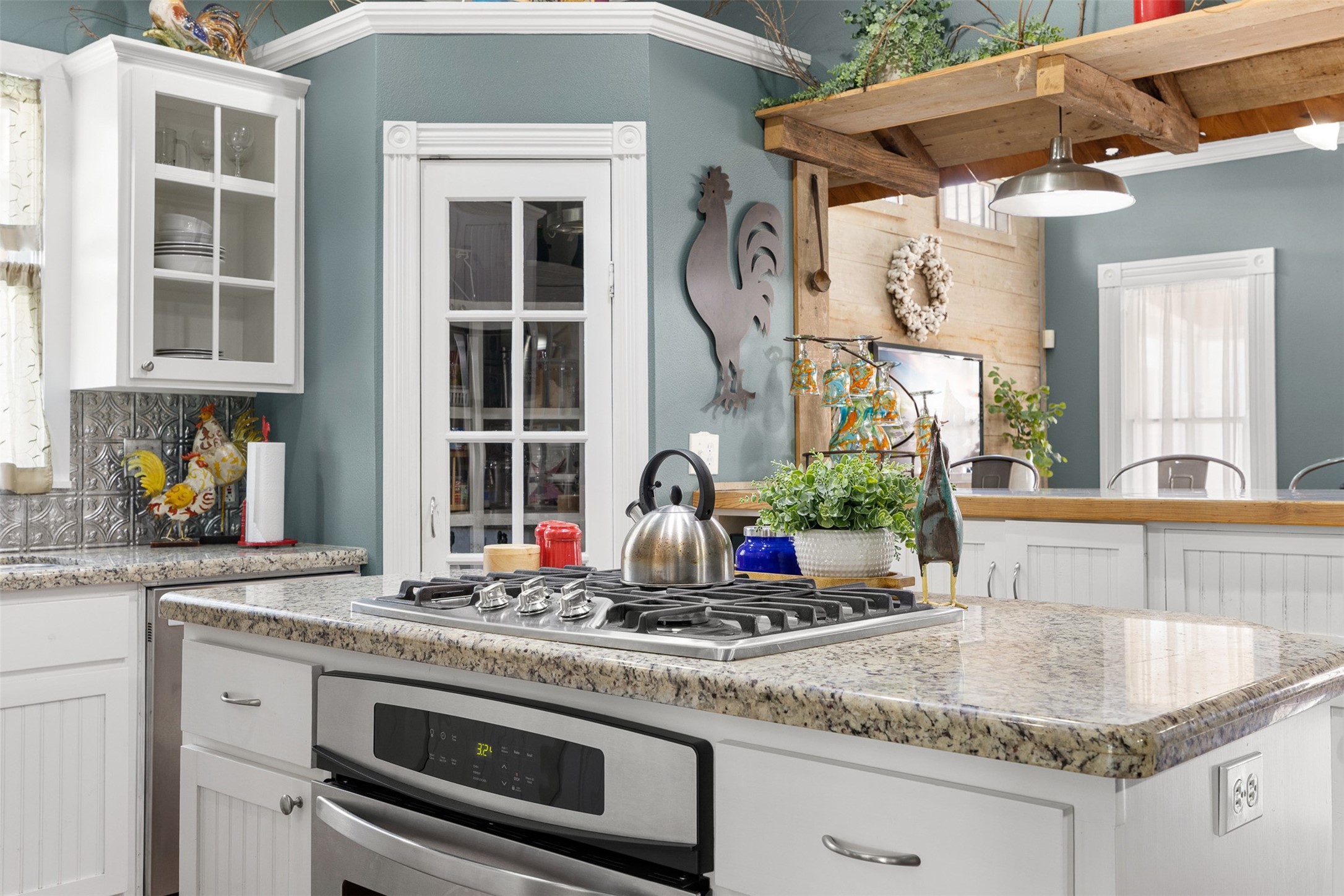 A granite-topped island provides additional preparation space and a natural gathering place in the heart of the kitchen.