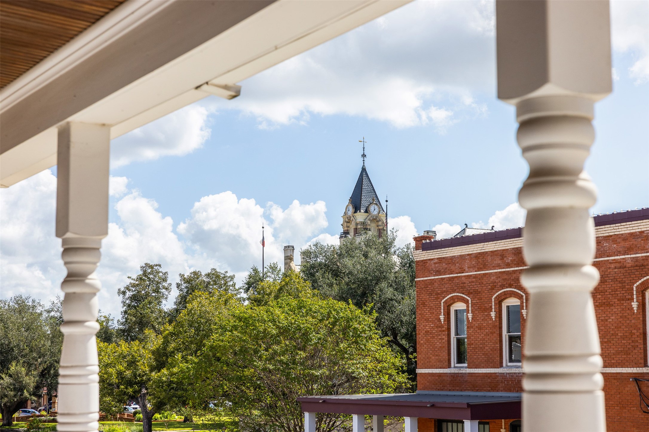 Enjoy a front-row view of La Grange history from the comfort of home, with the iconic Fayette County Courthouse clock tower rising above the trees and downtown rooftops.