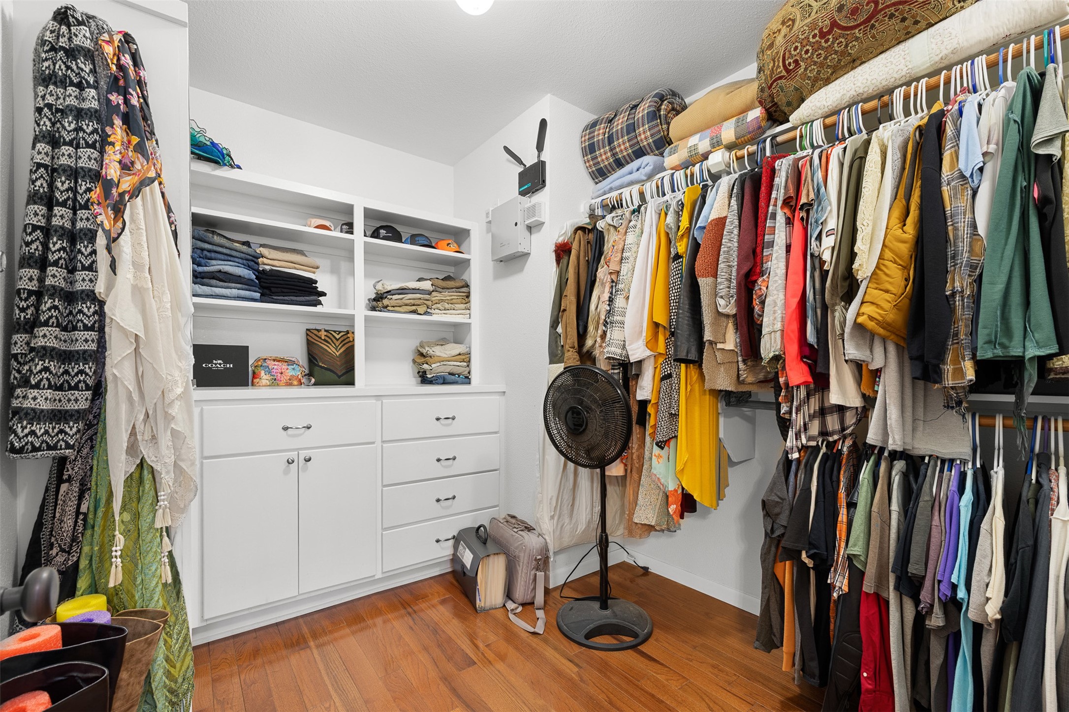 The primary walk-in closet offers abundant hanging space, built-in storage and room to keep everything beautifully organized.
