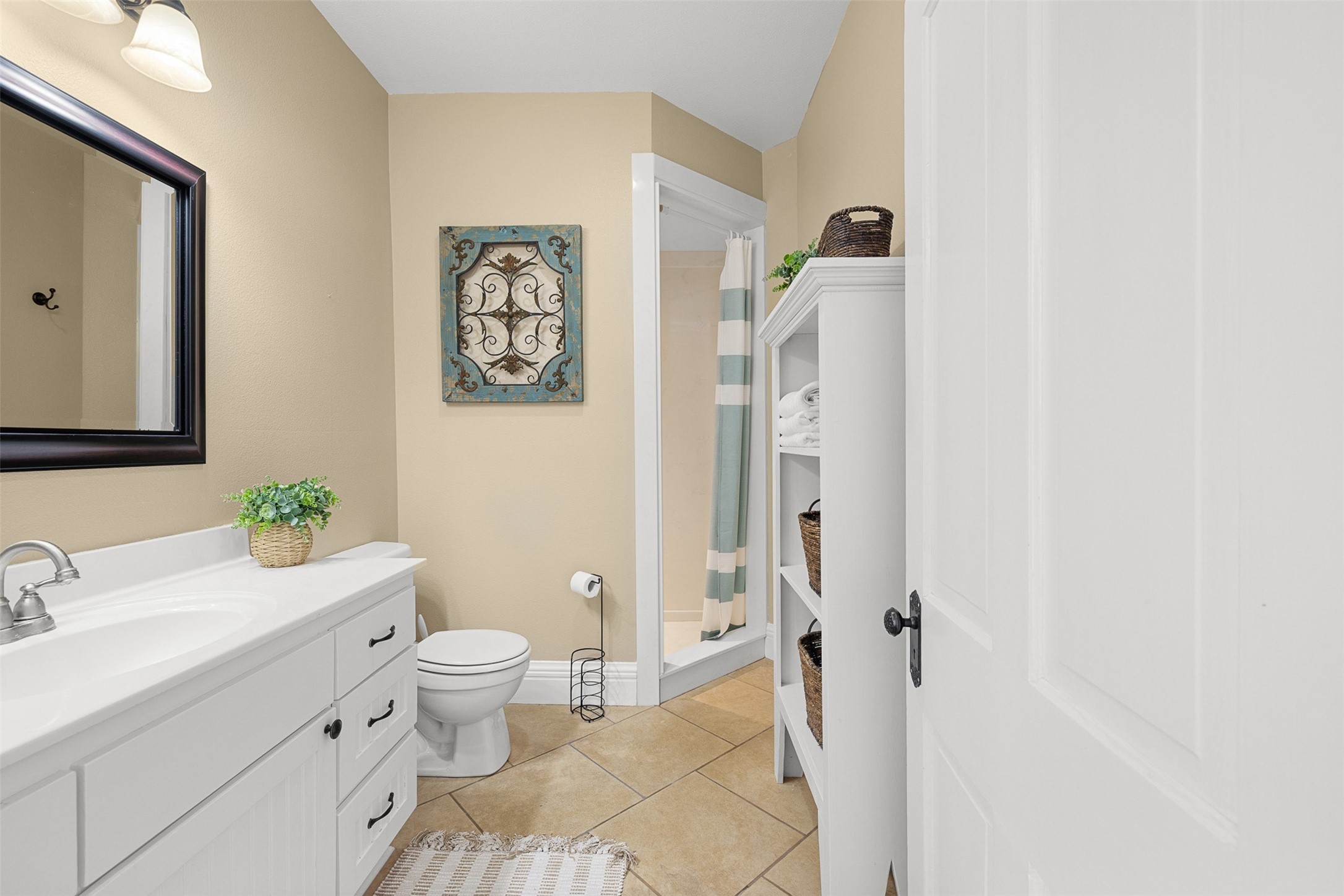 The updated upstairs bath serves the secondary bedrooms with a vanity, shower and clean, comfortable finishes.