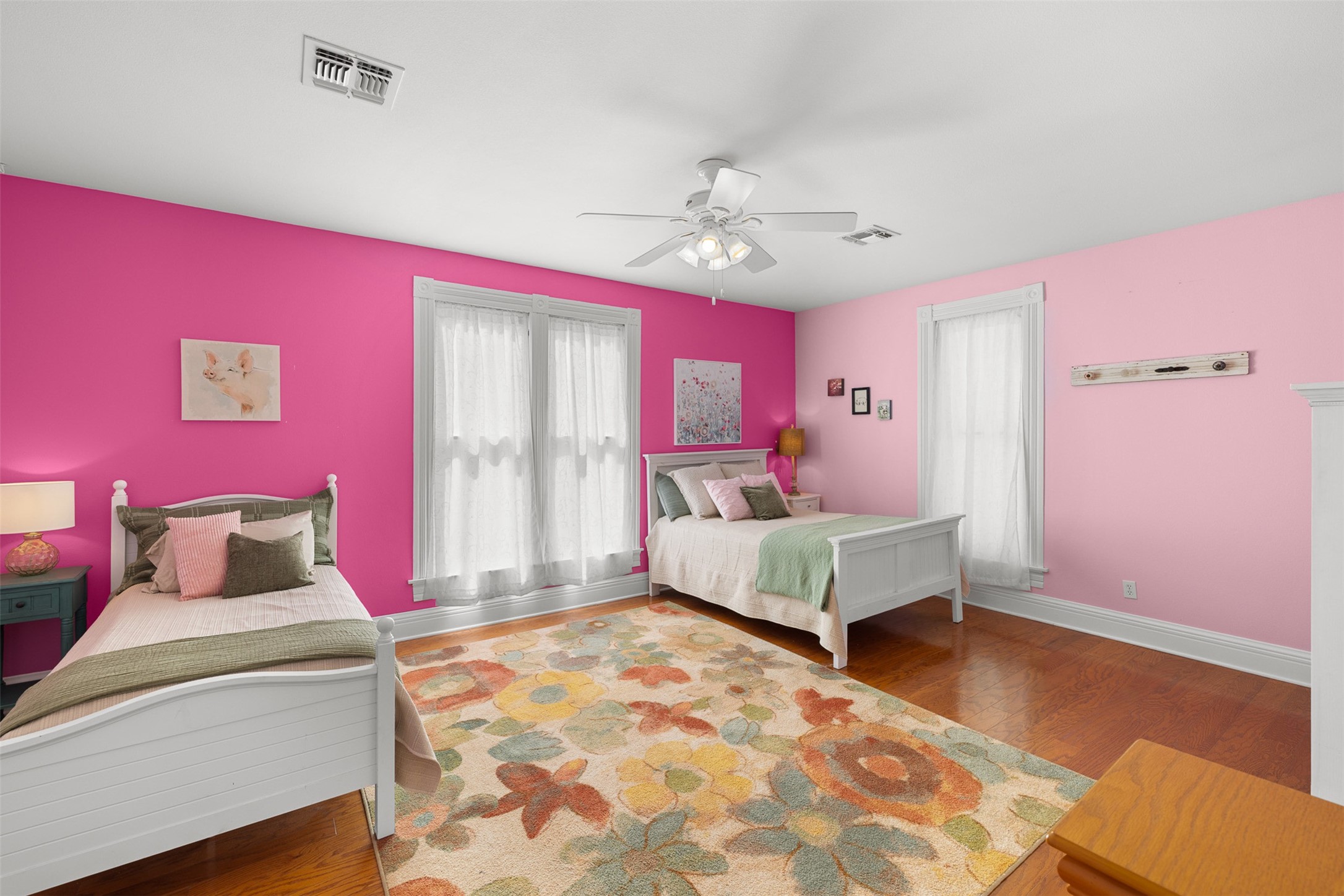 Bright and playful, this generously sized upstairs bedroom provides a welcoming retreat with abundant natural light.