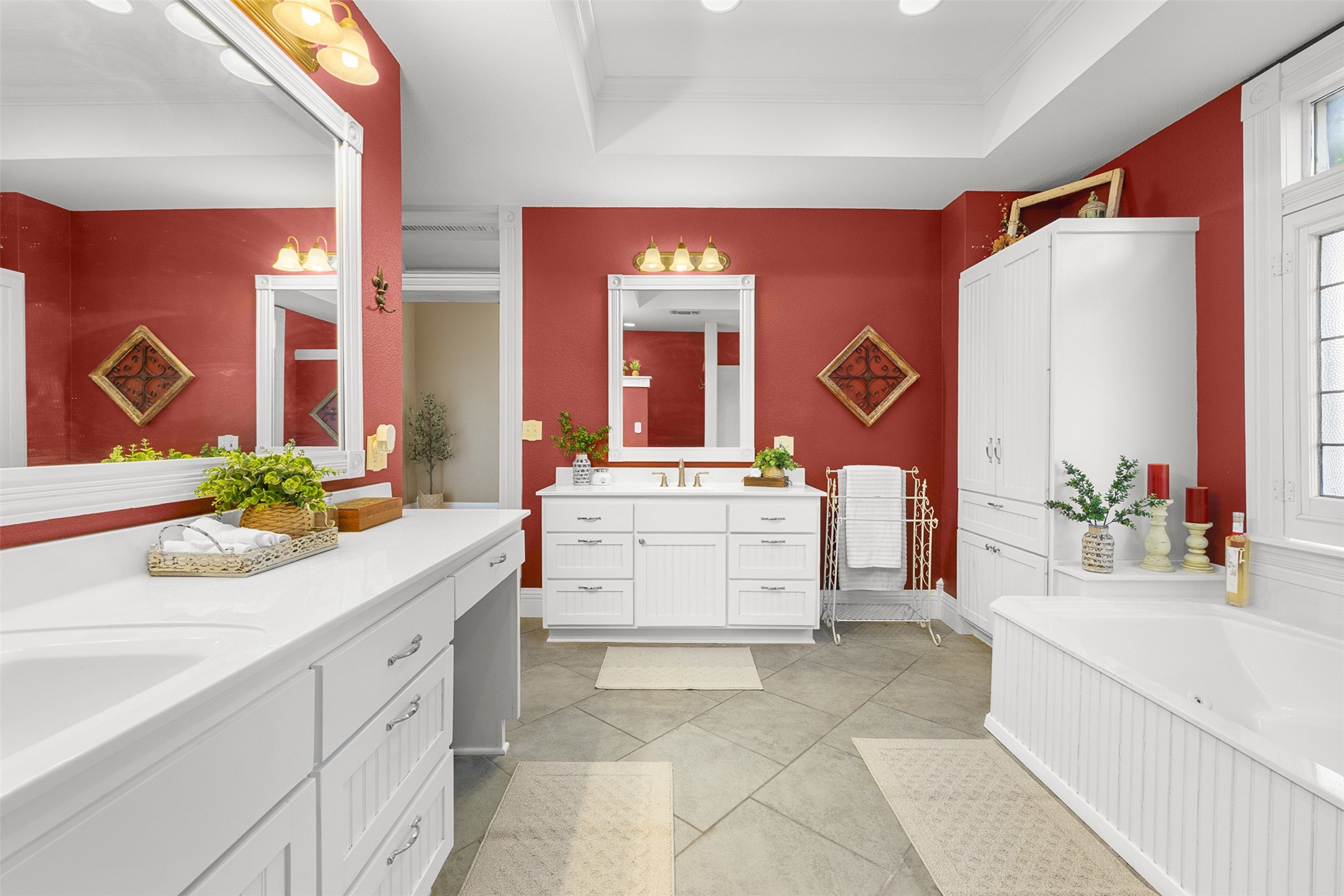 Another view of the primary bath showcases its dual vanities, bright finishes and spacious layout.