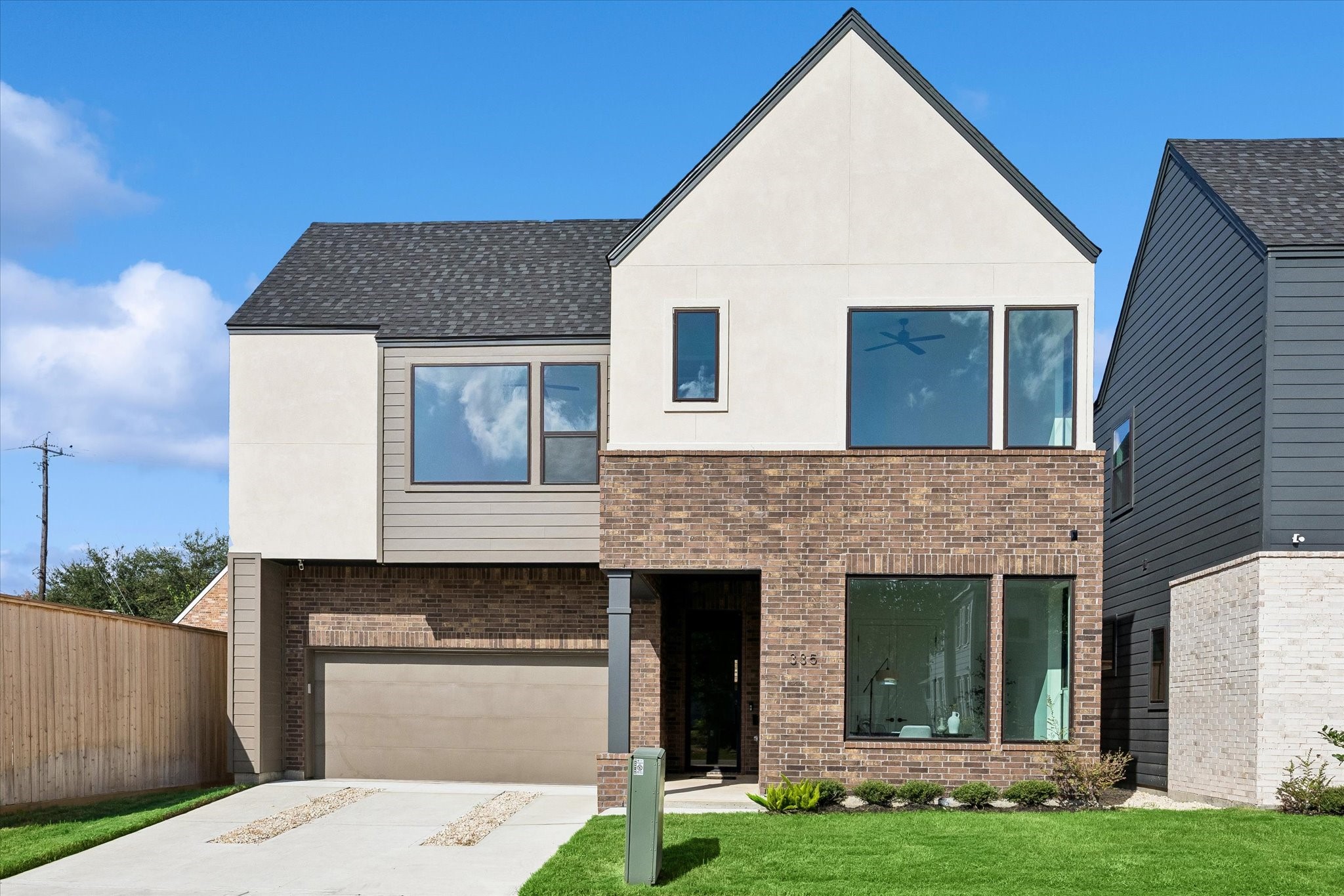 Striking modern architecture sets the tone with a sophisticated mix of warm brick, smooth stucco and horizontal siding. Oversized windows, a dramatic peaked roofline and an inset entry give this Centred Development new construction a distinctive presence from the moment you arrive.