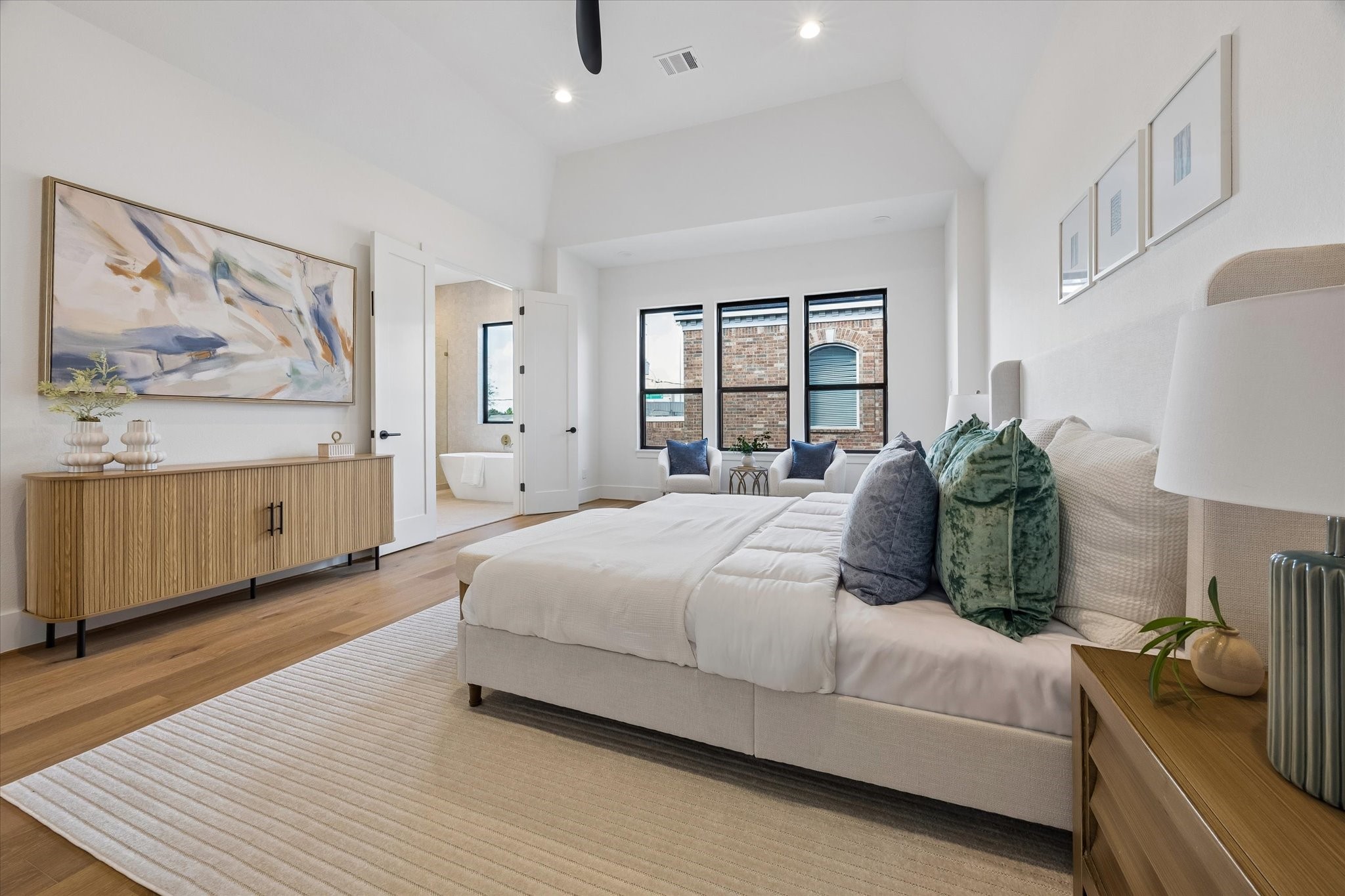 An alternate view showcases the primary suites impressive ceiling height and direct connection to the ensuite bath, creating a private and thoughtfully designed owners retreat.