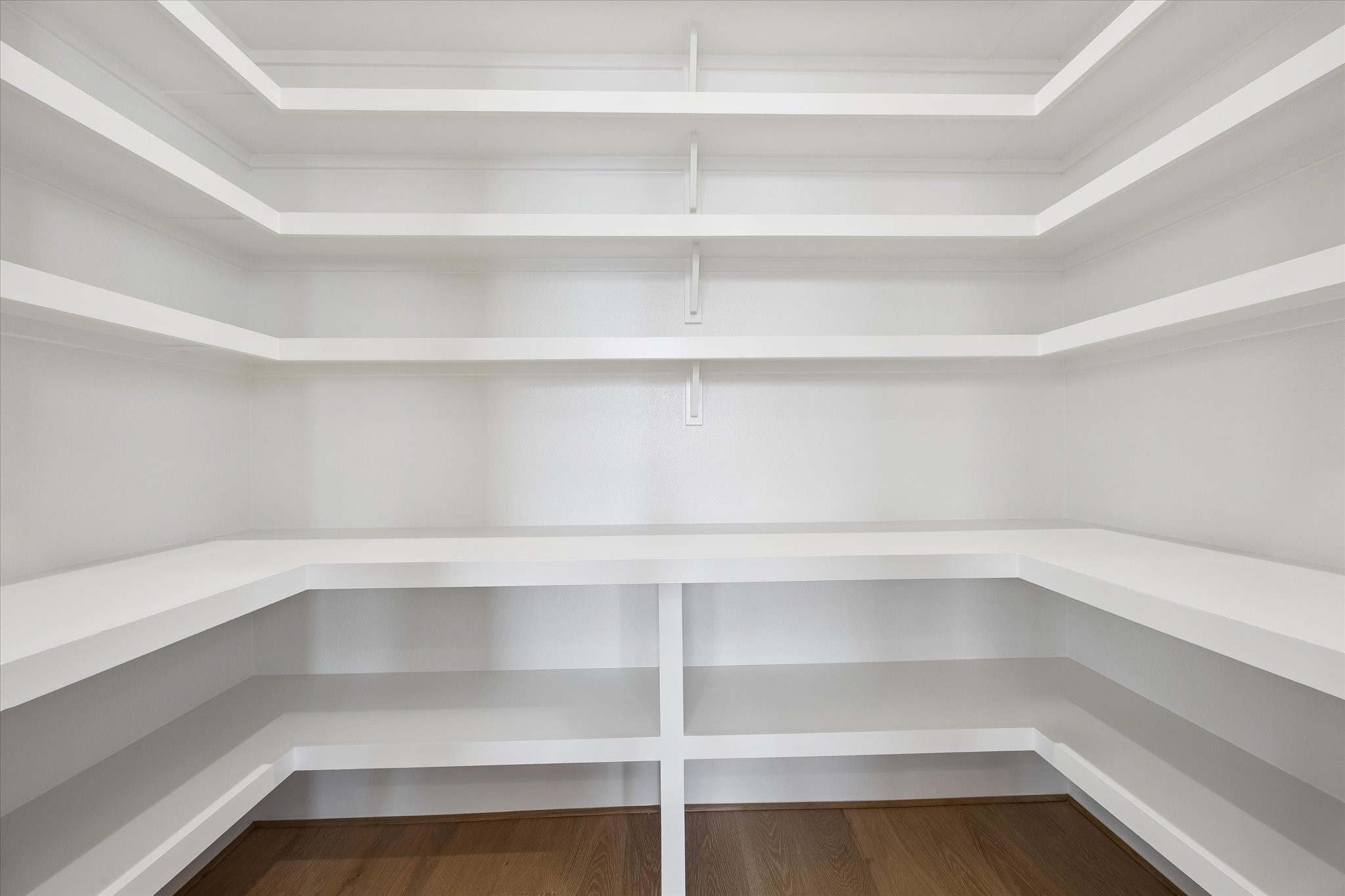 An oversized walk in pantry provides exceptional storage with wraparound shelving designed to keep everyday essentials organized and within easy reach.