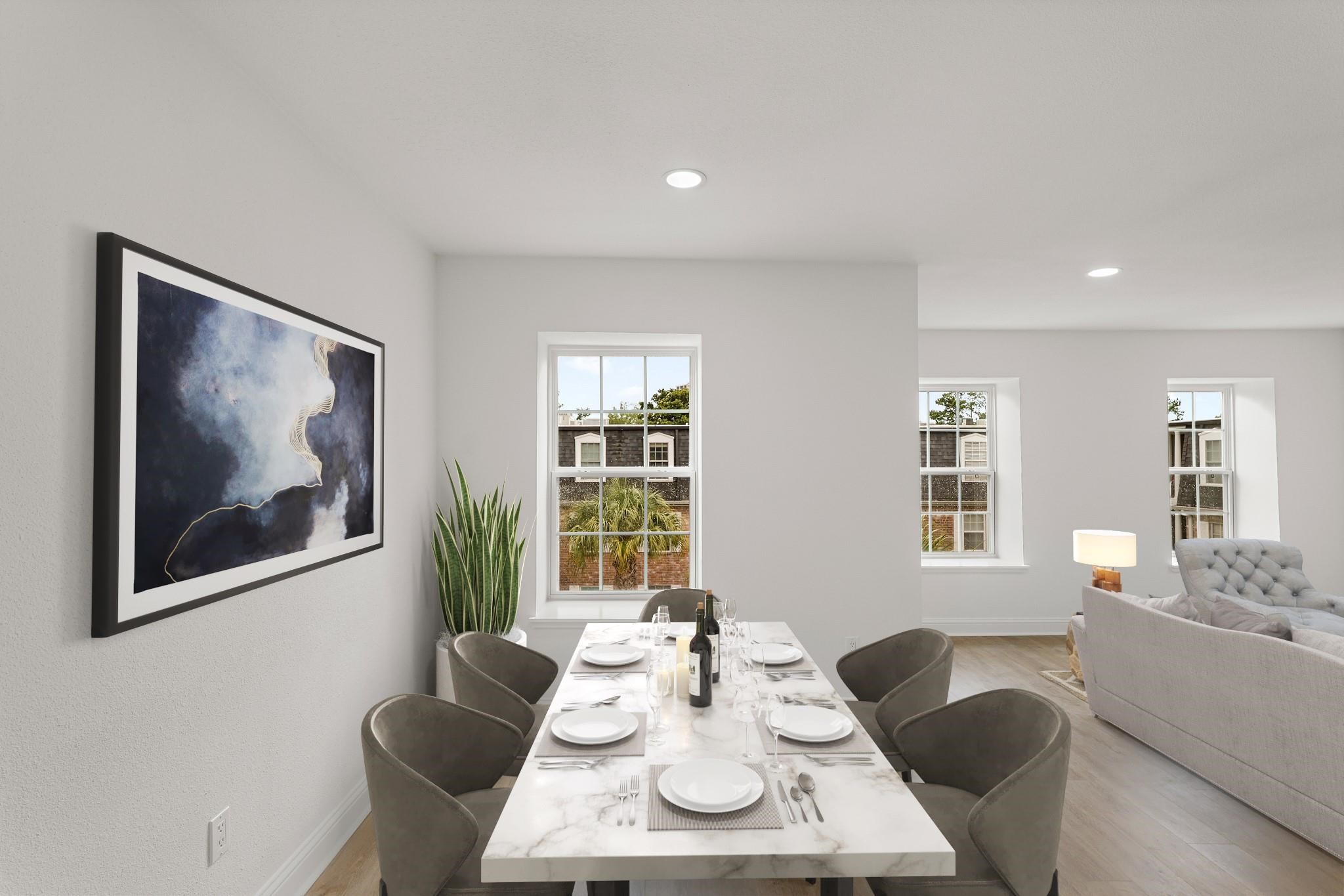 Bright and inviting dining area with a modern marble table, elegant seating, and large windows that fill the space with natural light, seamlessly connected to a cozy living room. Bright and inviting dining area with a modern marble table, elegant seating, and large windows that fill the space with natural light, seamlessly connected to a cozy living room.