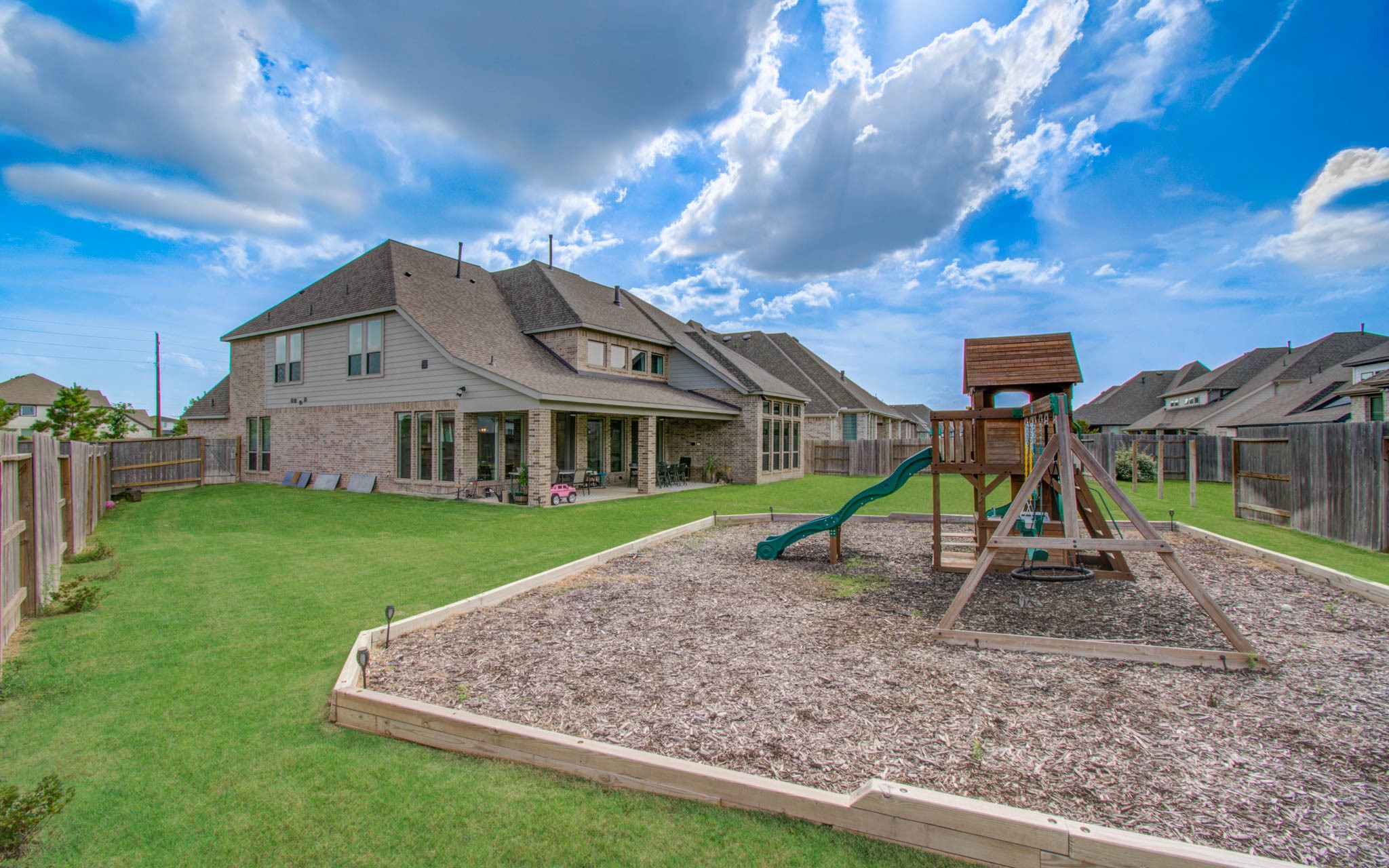Kids play set in backyard.