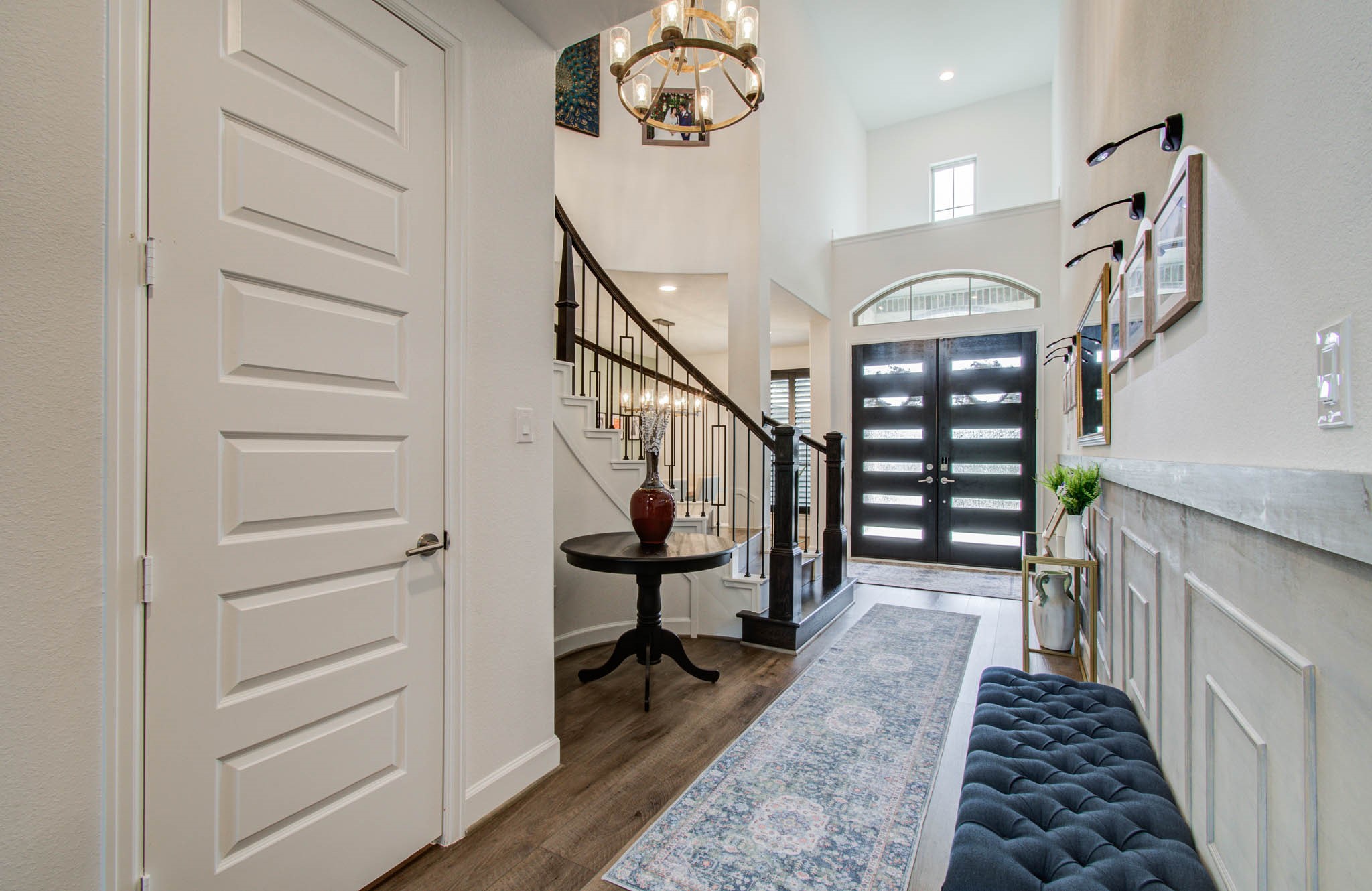 A grand cathedral entryway greets you with elegance, highlighted by an upgraded light fixture that adds a modern touch to the welcoming space.