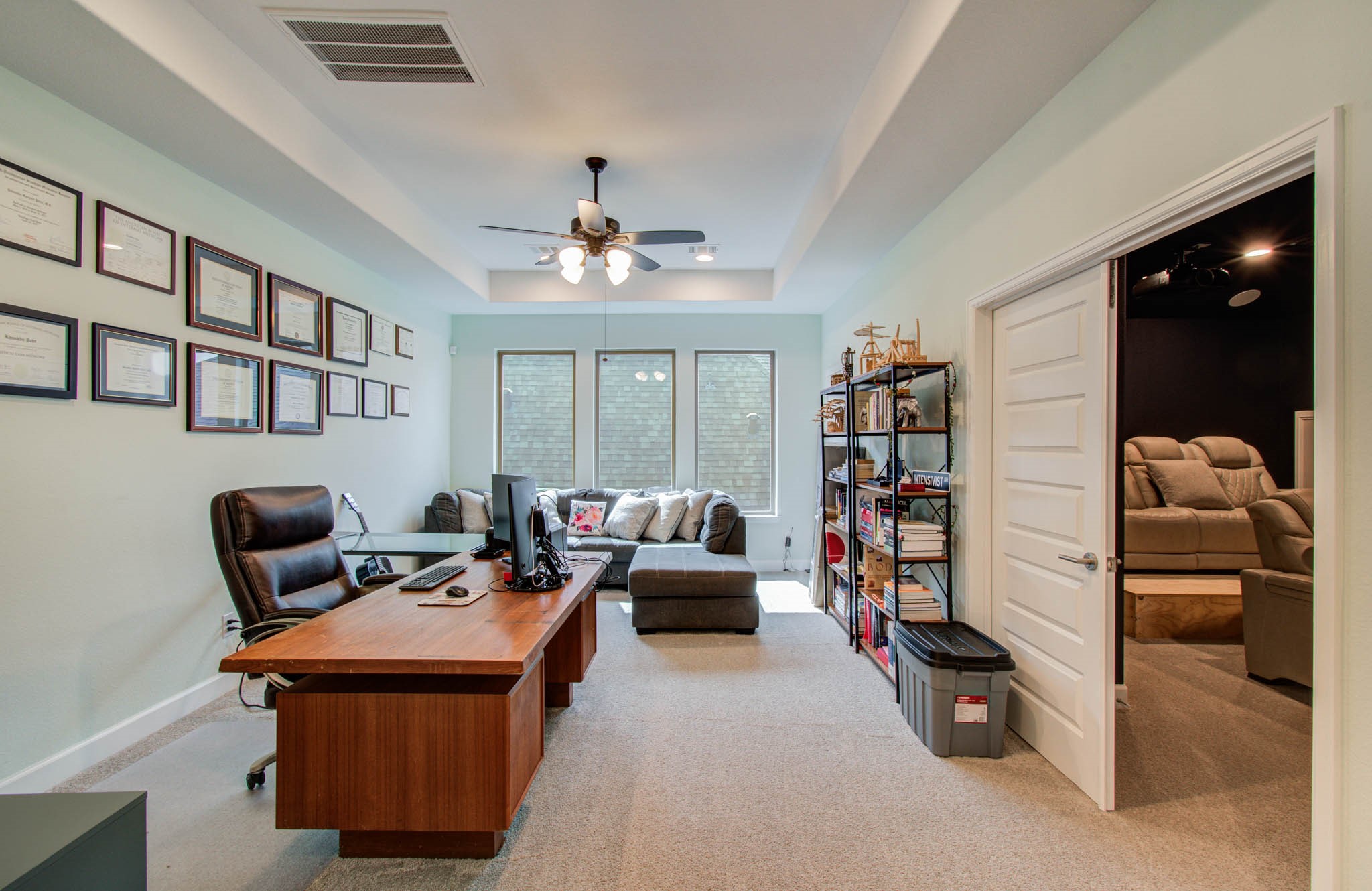 Upstairs, a versatile gameroom is currently transformed into a stylish and functional office space, perfect for remote work or study.