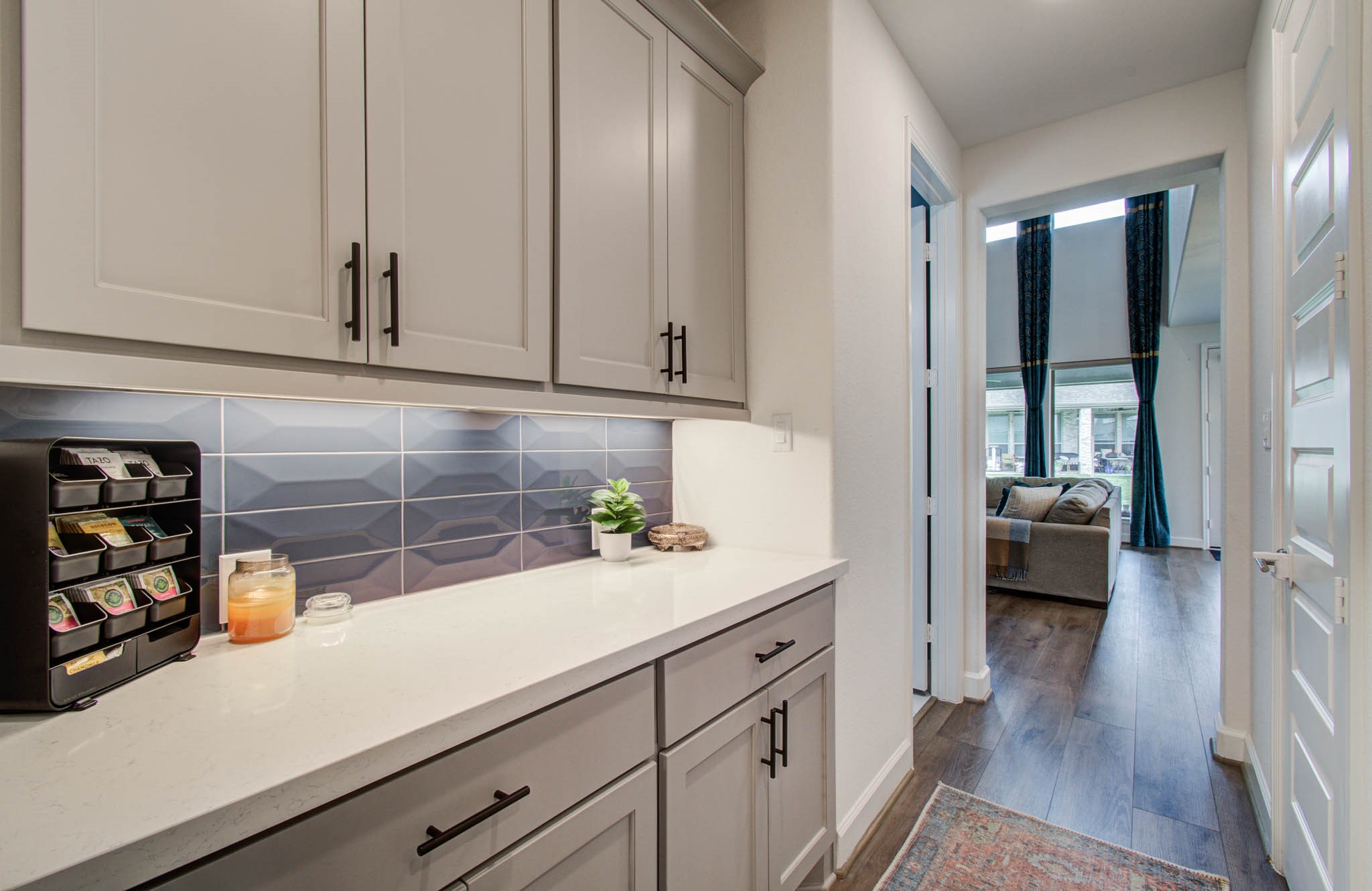 Versatile coffee bar or butler's pantry featuring sleek cabinetry and ample storage for all your essentials.