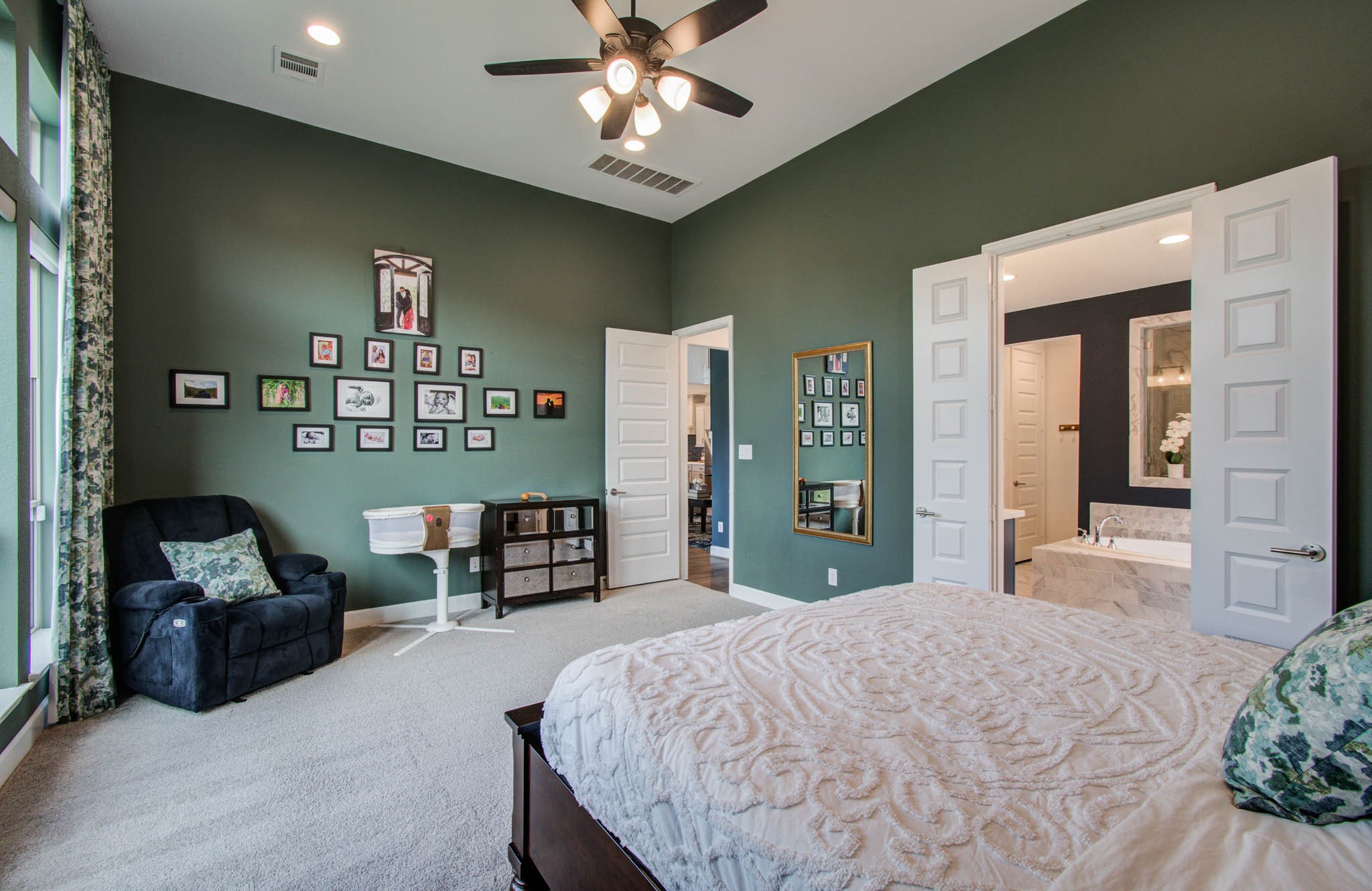 The room connects to a modern bathroom with double doors, adding a luxurious touch.