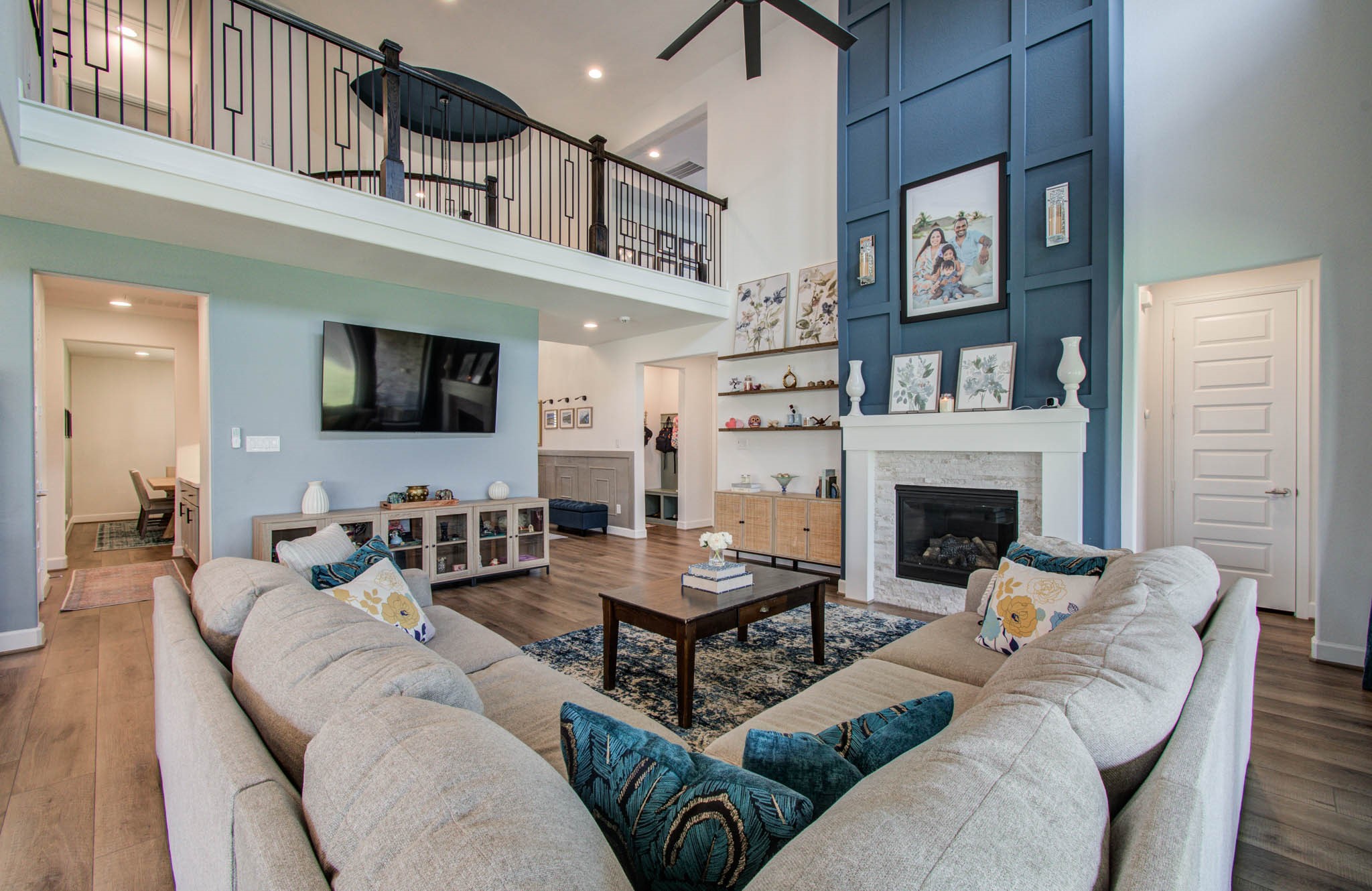 Elevate your living experience with stunning custom wood molding that gracefully extends to the ceiling, adding a touch of elegance and sophistication to this inviting space.