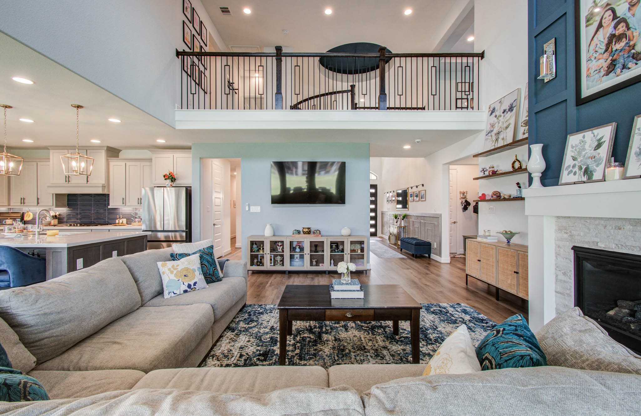 Experience the grandeur of a two-story living room that seamlessly blends elegance and comfort, featuring a stylish open layout perfect for both relaxation and entertaining.