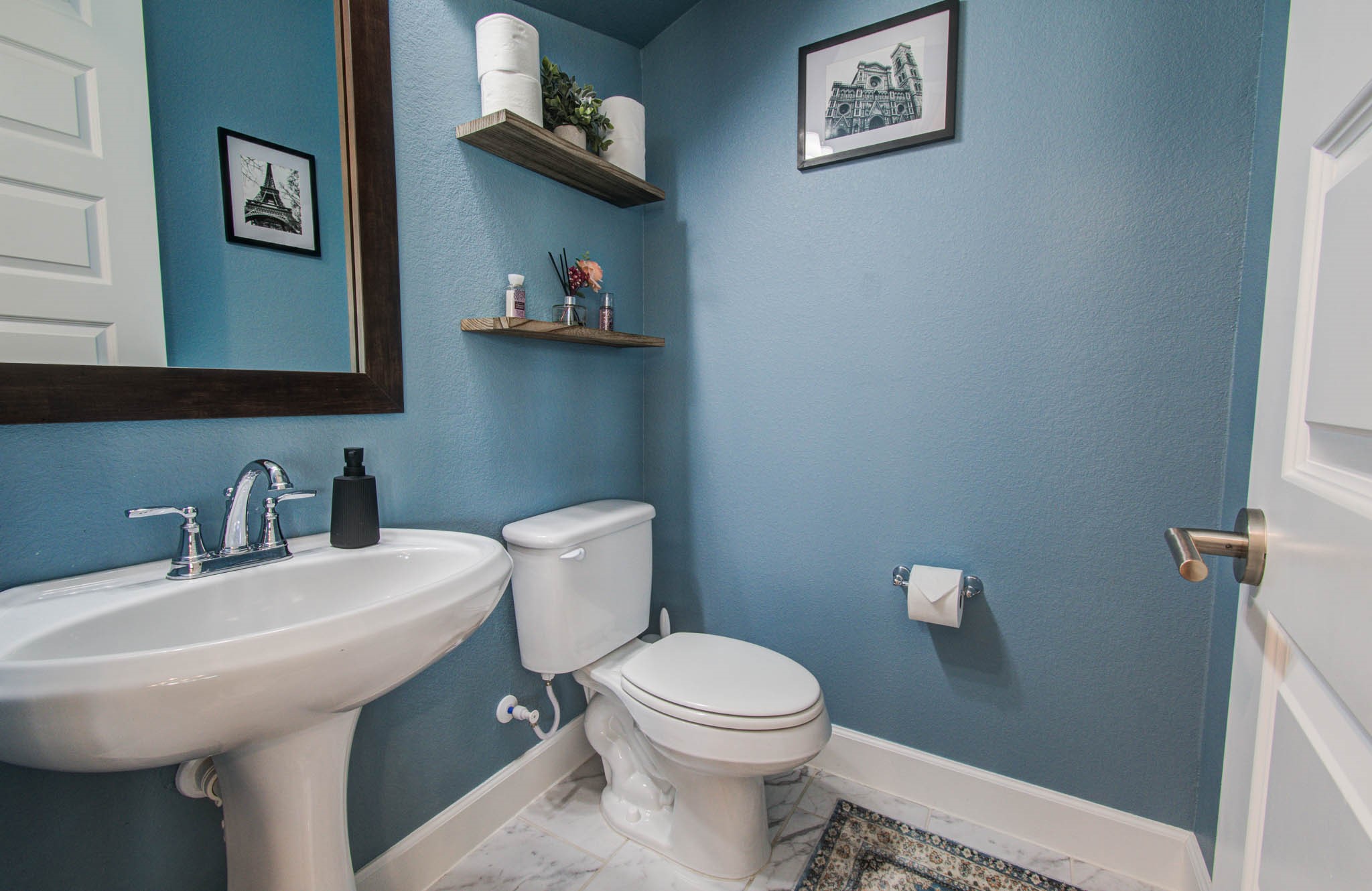 Charming powder bathroom featuring elegant floating shelves for a stylish and functional touch.