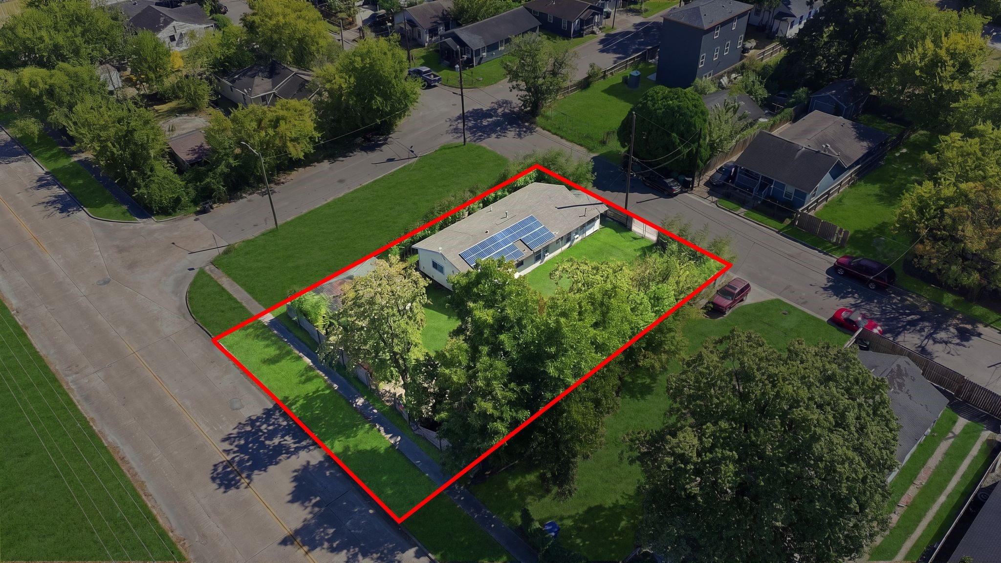 The lot features large mature trees that provide natural shade.