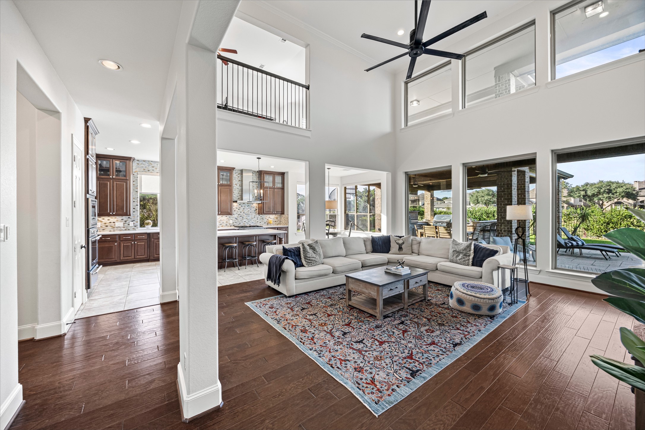 Open living area with soaring ceilings and walls of windows bringing in natural light. New windows (2024). All new lighting on dimmers.