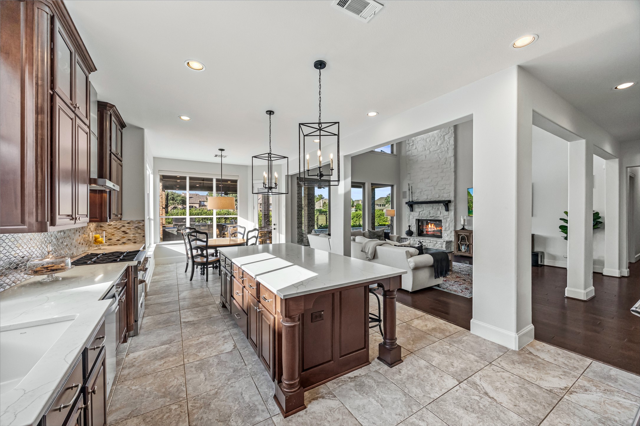 Chef's kitchen with large center island opening to the breakfast and living areas. New quartz countertops and backsplash (2024). Reverse osmosis tied into sink and ice machine.