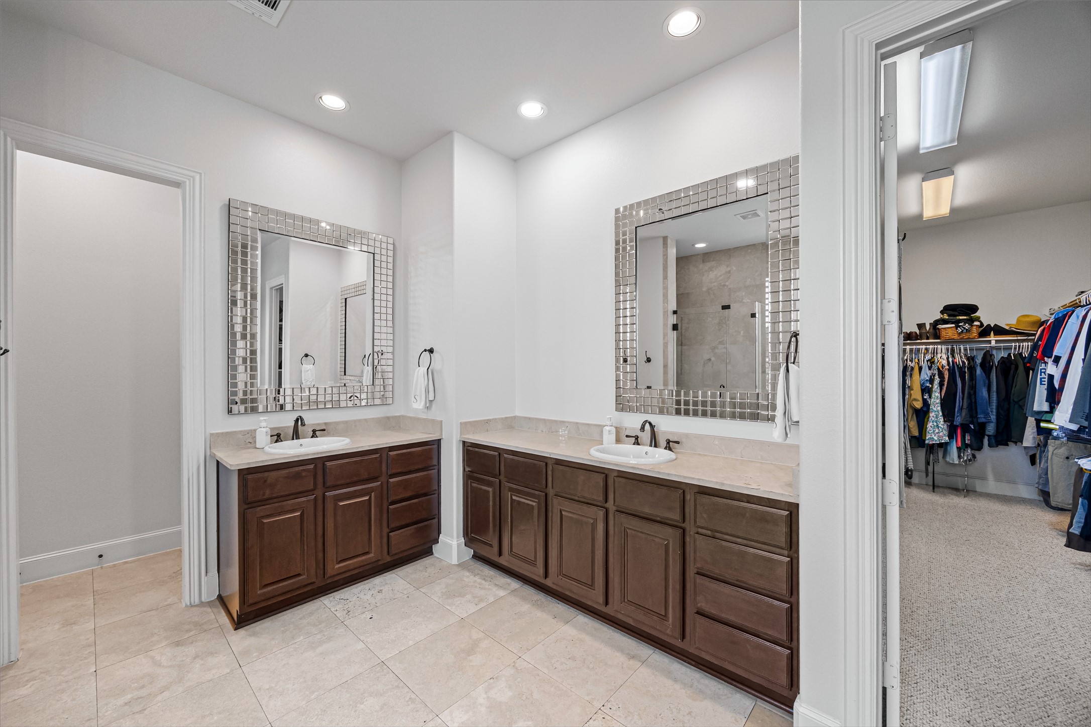 Primary bath with dual vanities, ample counter space, and access to the closet. All new lighting on dimmers. Updated paint throughout.