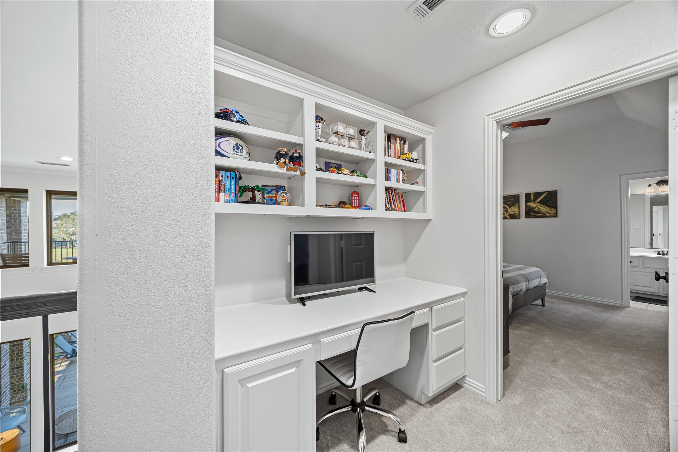 Built-in desk and custom shelving creating a functional workspace