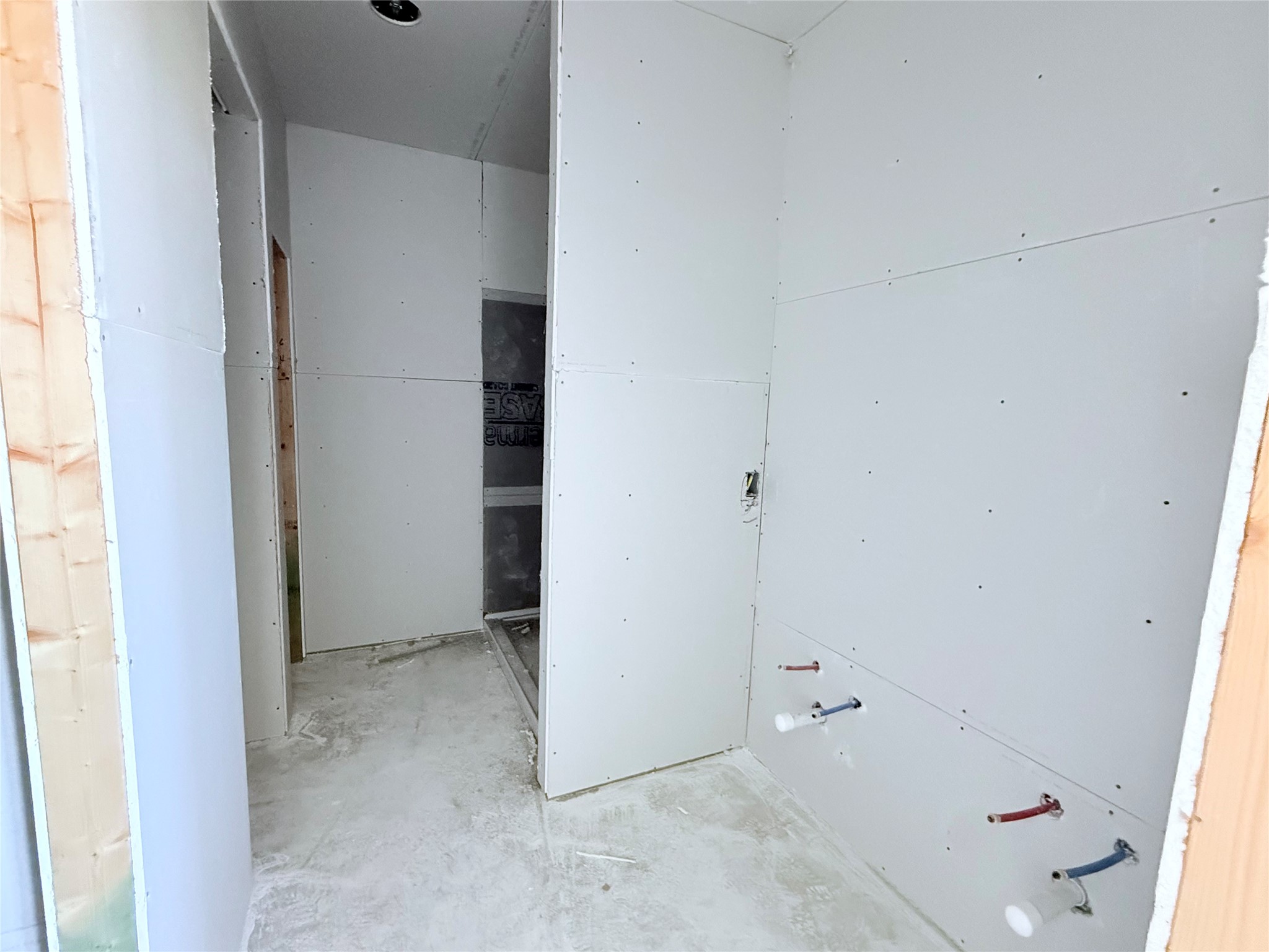 Primary bathroom with double sink vanity, walk in shower and closet