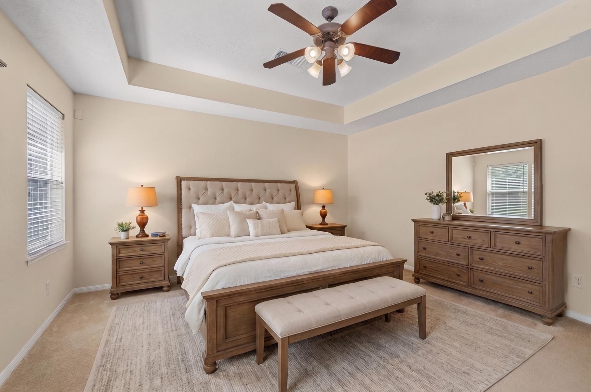 Primary suite located on the first floor with an en-suite bathroom, high ceilings, and beautiful view of the pool (Virtually staged). Primary suite located on the first floor with an en-suite bathroom, high ceilings, and beautiful view of the pool (Virtually staged).