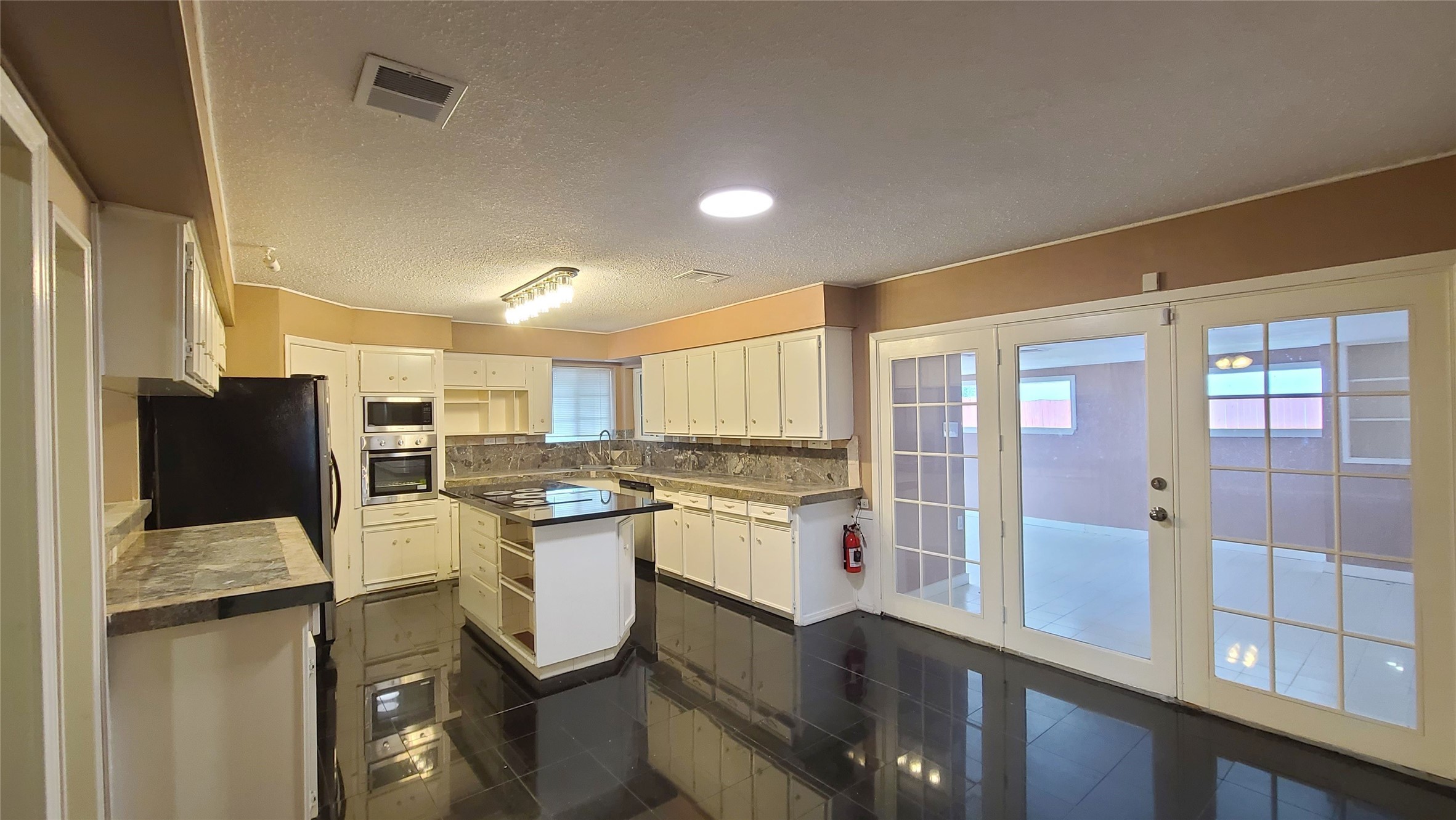 Experience the heart of the home with a sleek island kitchen featuring recent stainless appliances, perfect for modern culinary adventures.