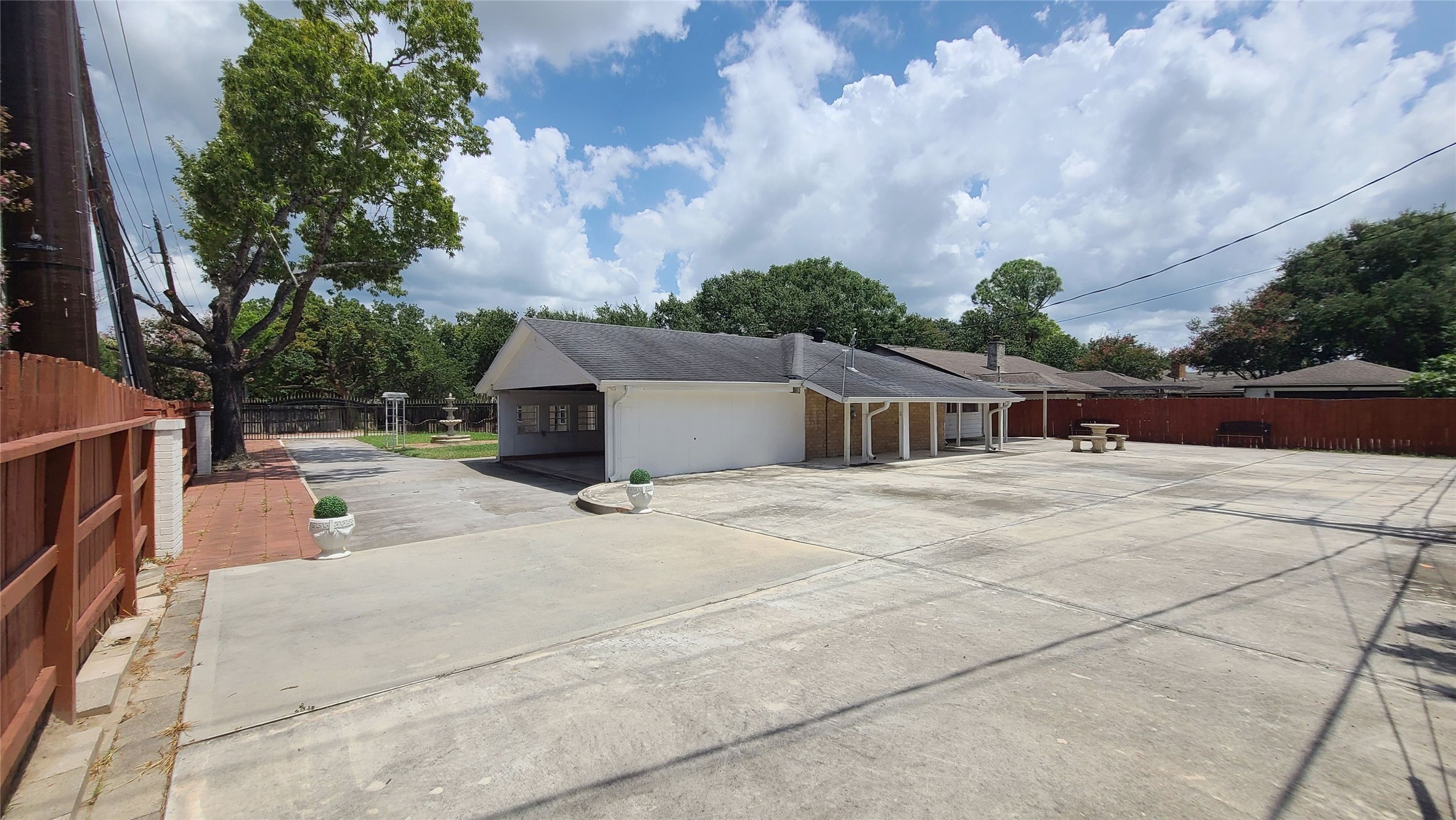 Expansive parking area perfect for family gatherings or transforming into a vibrant basketball court.