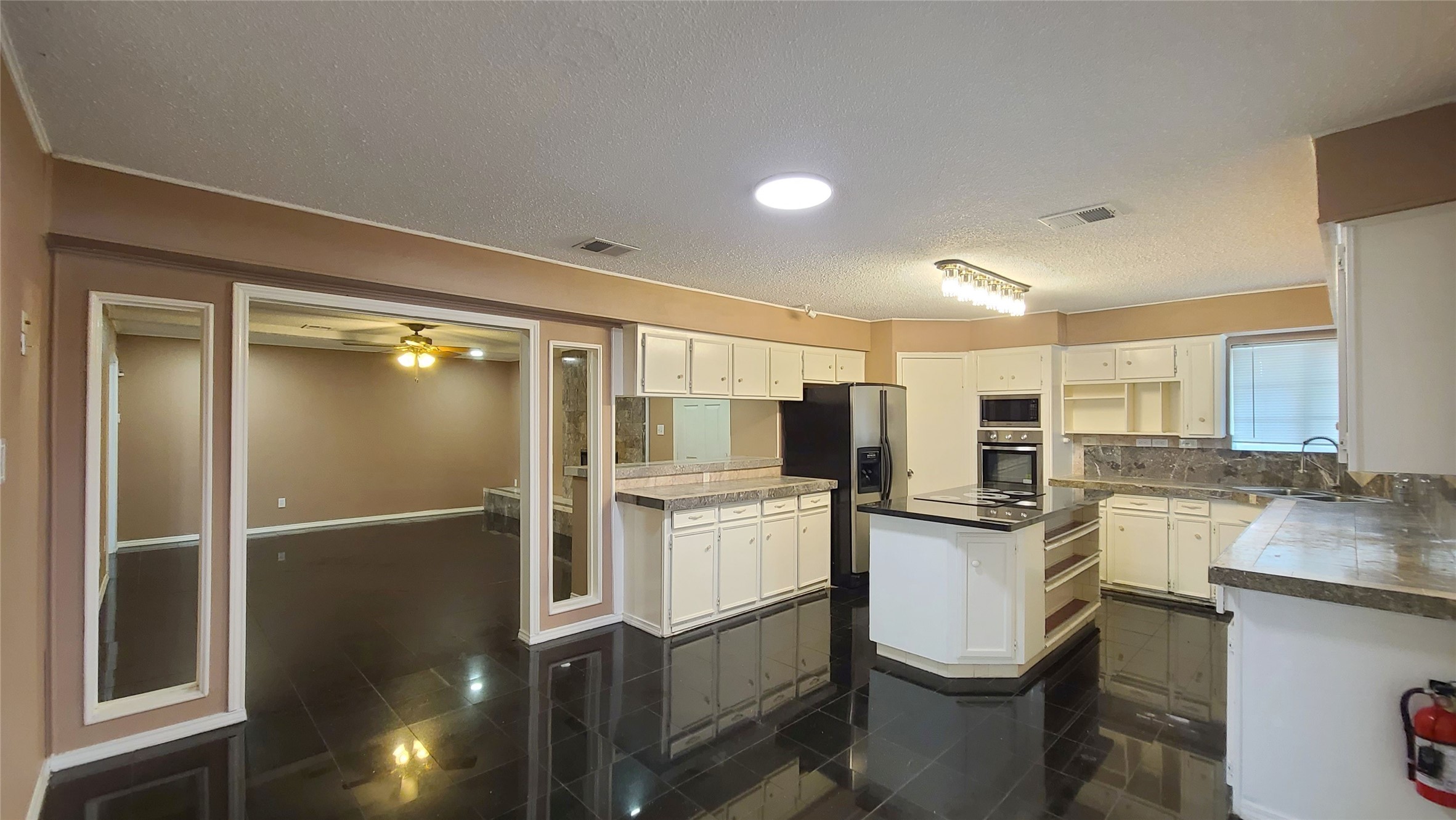 Experience seamless living in this inviting space where the kitchen effortlessly opens to the family room, perfect for entertaining and everyday life.