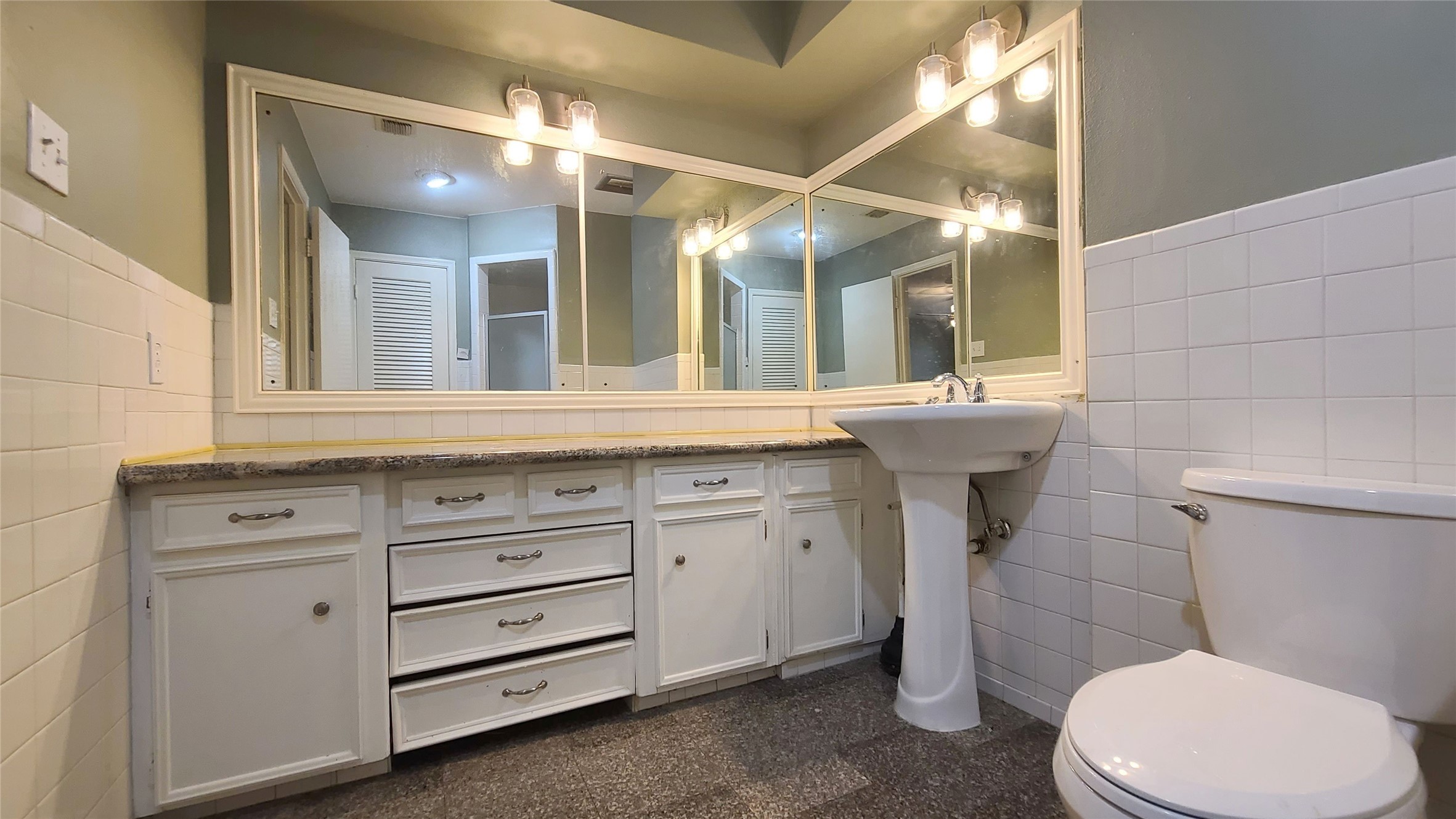 Experience the serene ambiance of the primary bath, featuring soft green walls and sleek finishes that create a tranquil retreat.