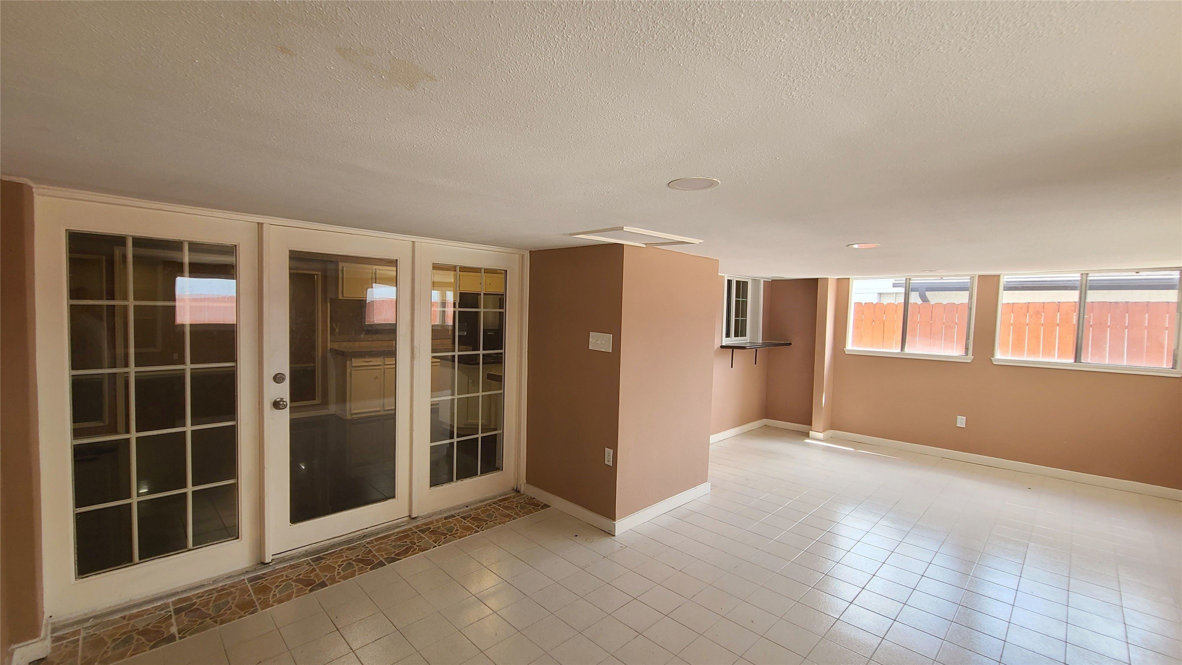 This extra room has tile floor, full of sun light