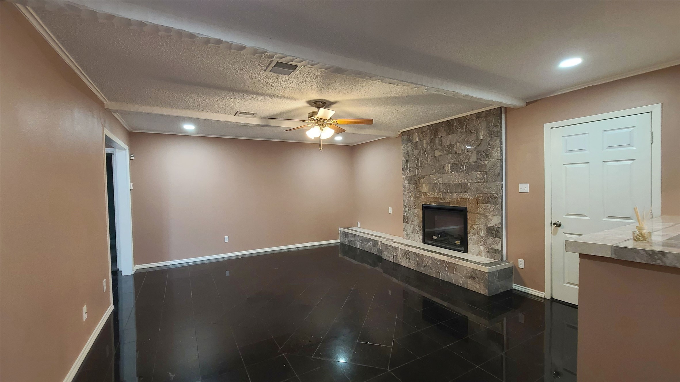 The family room boasts a beautiful tile fireplace, creating a warm and inviting focal point for gatherings.