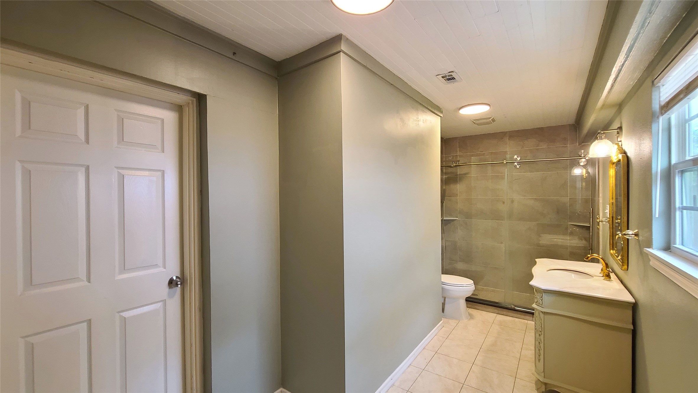 Discover modern elegance in the heart of this home, featuring a sleek kitchen with abundant natural light and an elegant full bath with a spacious shower.