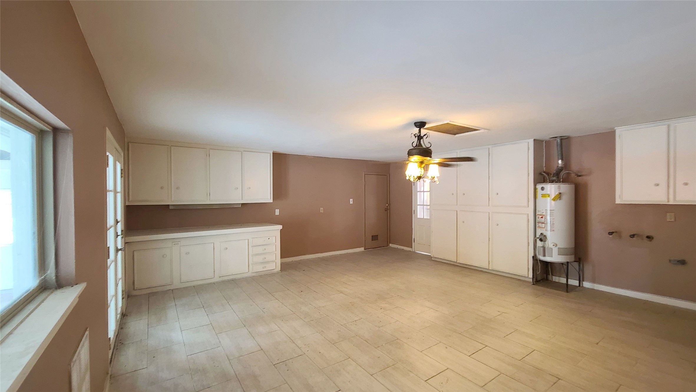 This spacious extra room has plenty cabinets and tile flooring