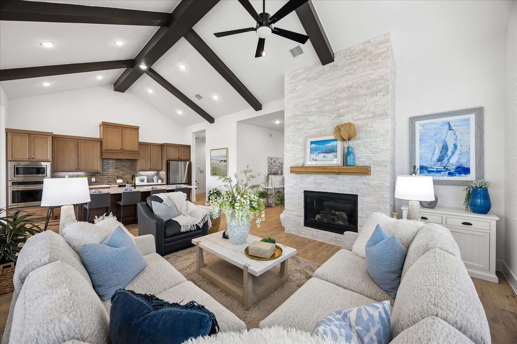 The home features an open-concept layout where views extend seamlessly from the front entry through the kitchen, creating an inviting flow and effortless connection throughout the living space.